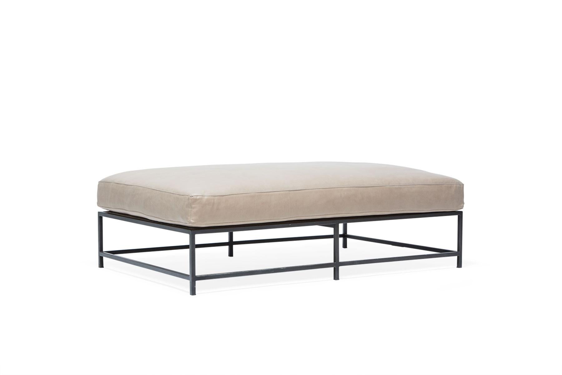 The Inheritance Bench is a versatile piece that can be used as a chaise extension on any sofa, as an independent seating option or as a large upholstered coffee table. 

This variation is upholstered in a smooth smoke leather. The foam seat cushions