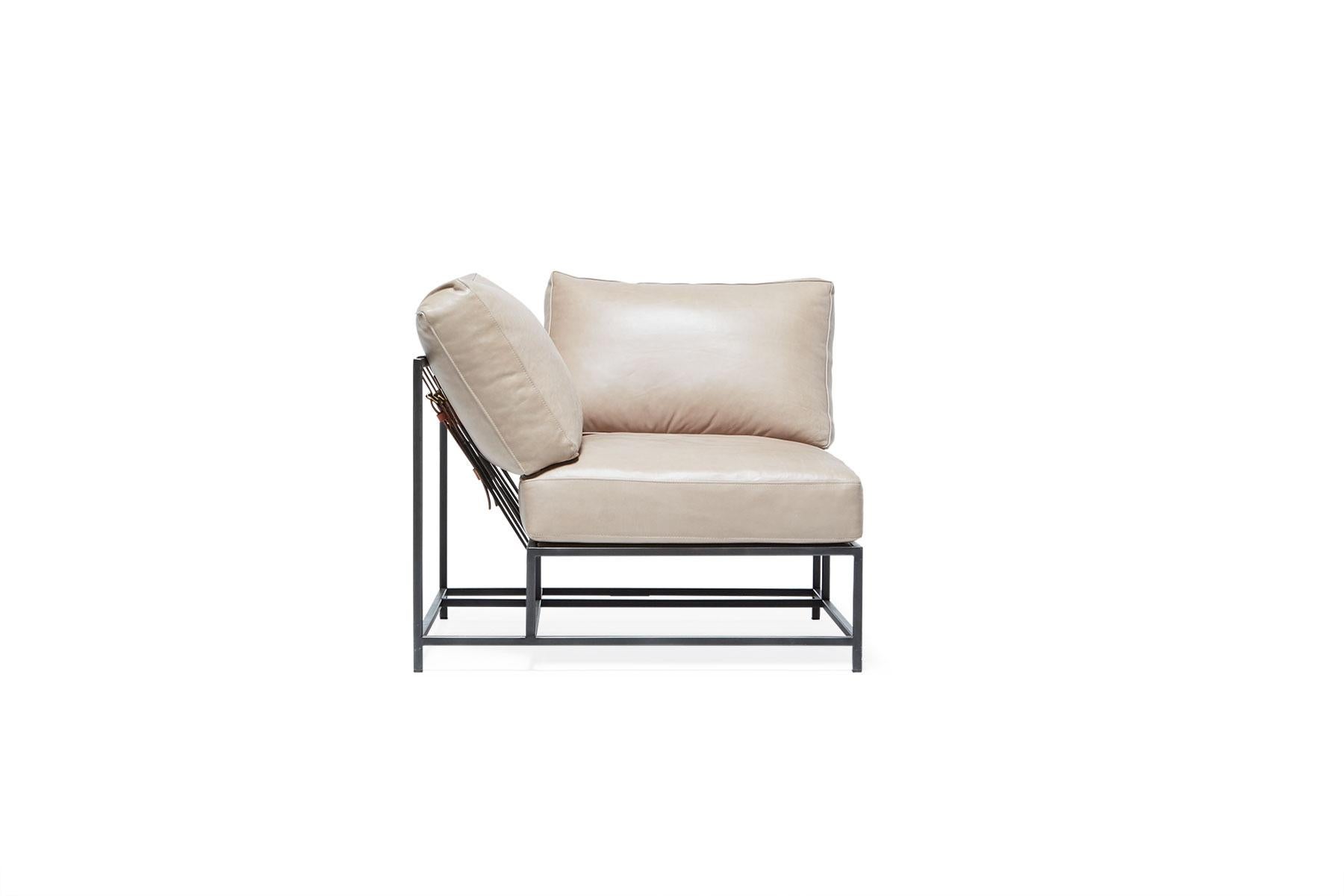 The inheritance corner chair can be used as a standalone piece, or as part of a modular sectional with other Inheritance pieces.

This variation is upholstered in a light smoke leather. The foam seat cushions have been wrapped in down, allowing