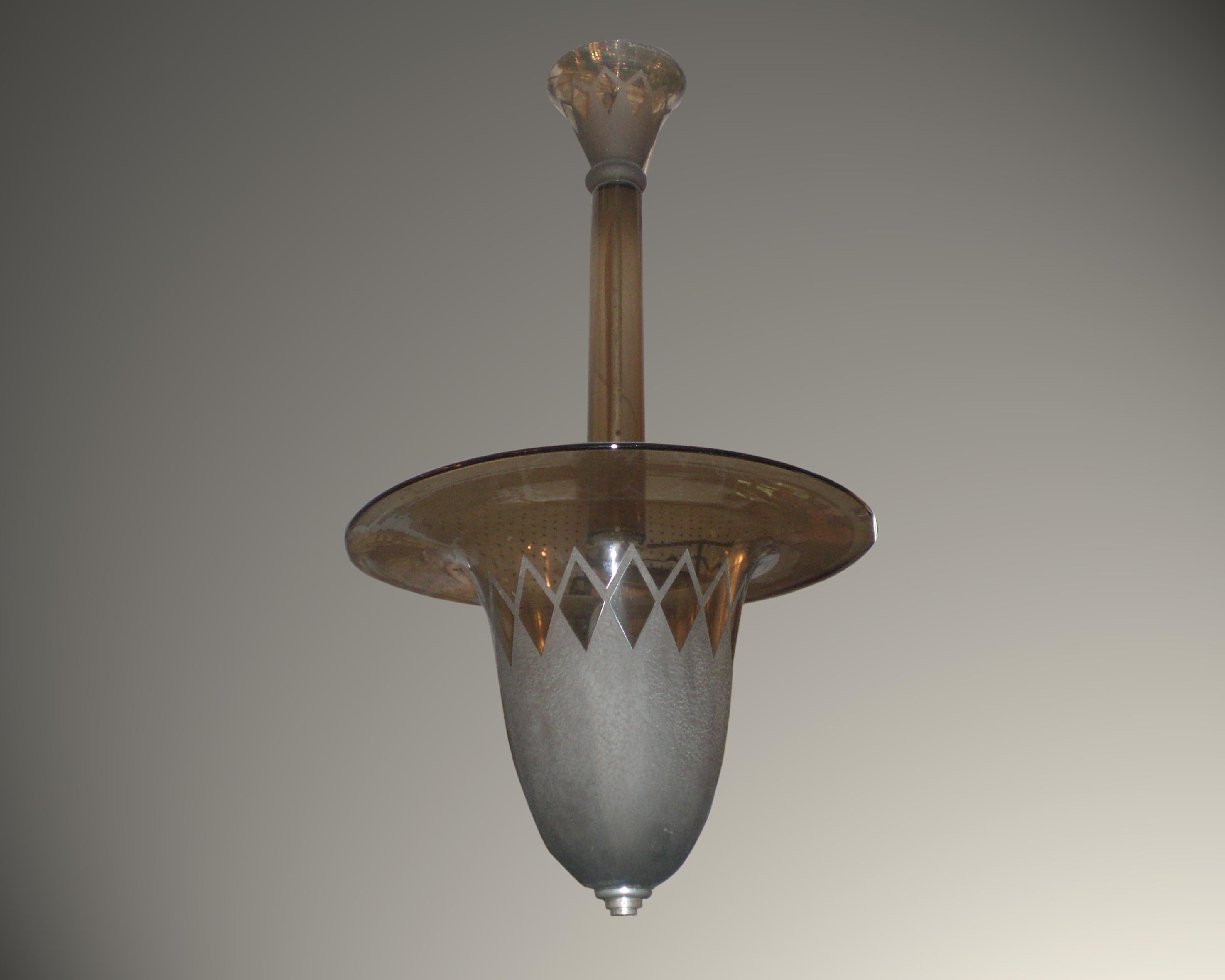 Original French Art Deco smoke tinted acid etched art glass chandelier by Daum Nancy. A polished and frosted bell shaped dome bearing diamond patterns is gracefully suspended by the original central glass shaft and ends with the original matching