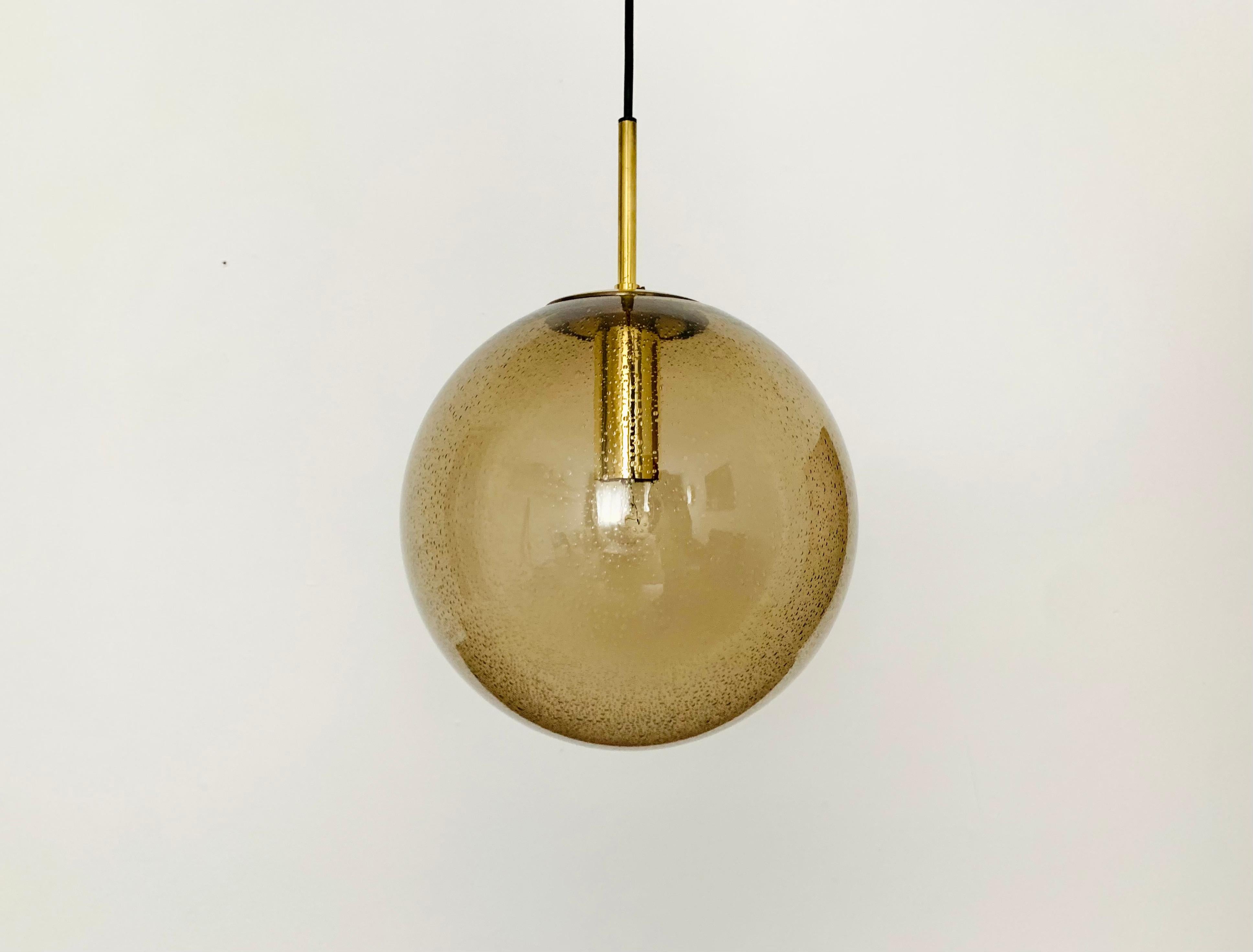 Fabulous bubble glass pendant lamp from the 1960s.
The lamp is very elegant and an eye-catcher in every room.
The structure in the glass creates a spectacular play of light.

Manufacturer: Glashütte Limburg

Condition:

Very good vintage condition