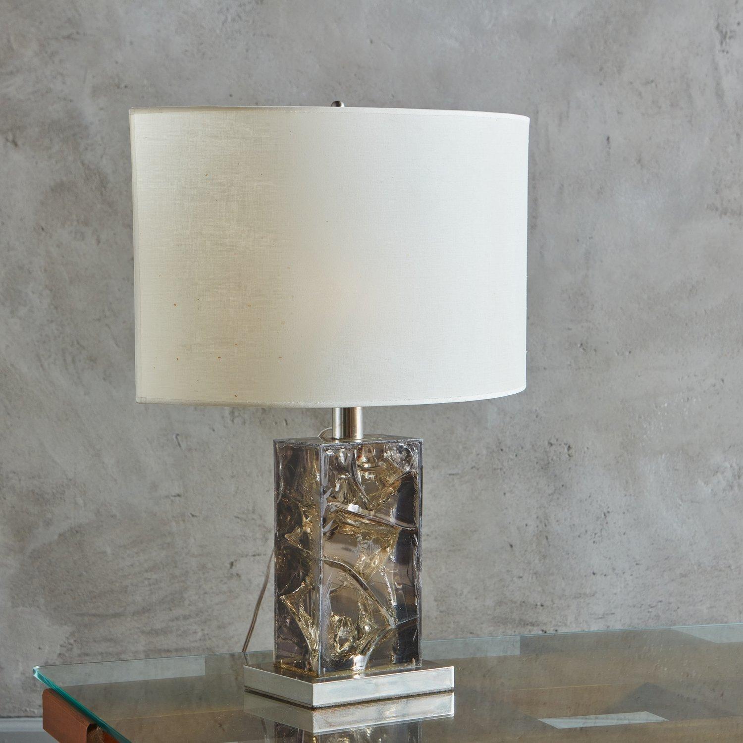 A vintage French table lamp featuring a rectangular fractured resin body in a gorgeous smoked hue with a chrome metal base and hardware. This lamp retains its original almond shaped white fabric shade. Unmarked. Sourced in France, 20th