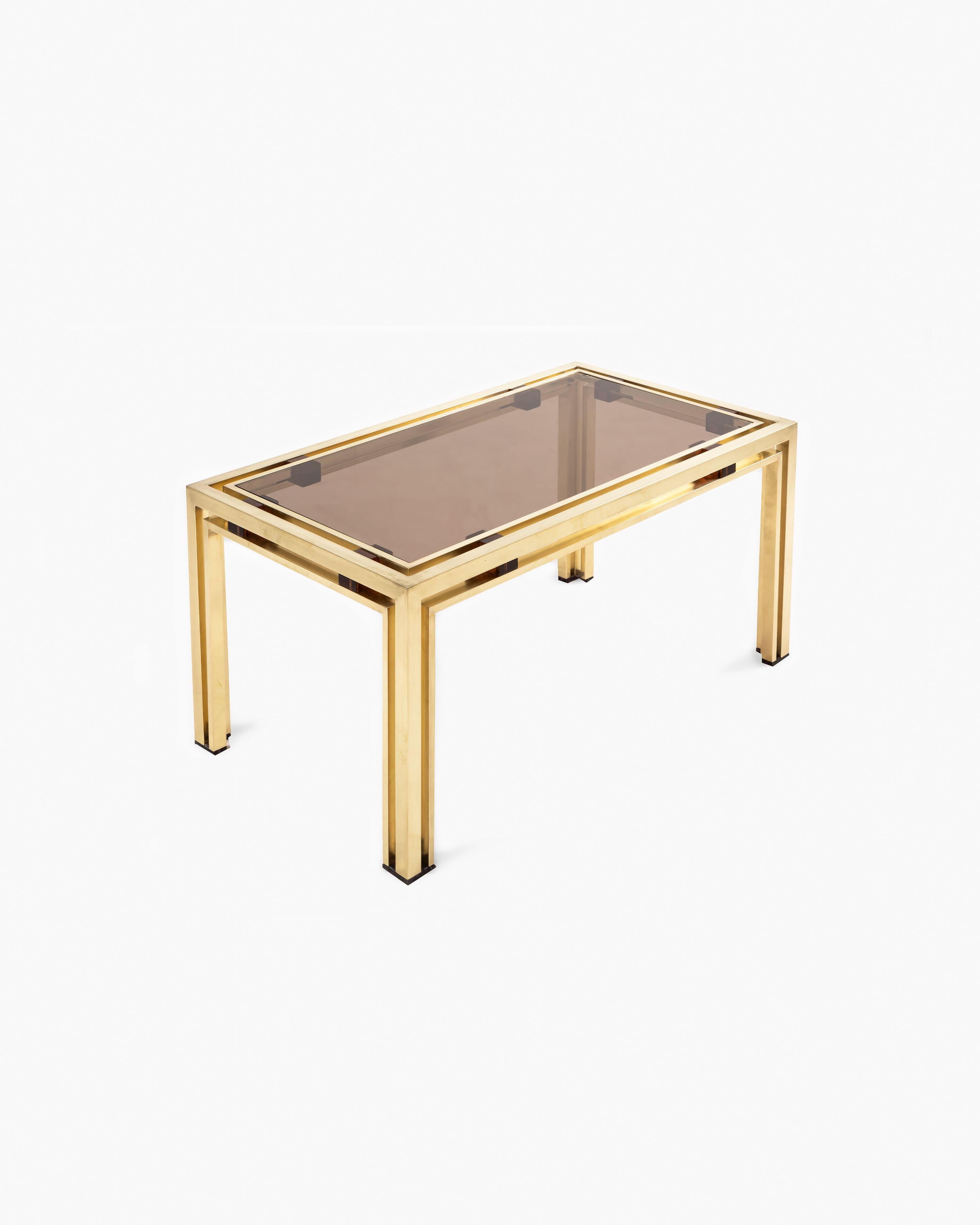 Elevate your living space with this exquisite coffee table by Romeo Rega. Crafted circa 1970, this table showcases a brass frame that beautifully encases a smoked glass top, accentuated by amber lucite details.

With its sleek and contemporary