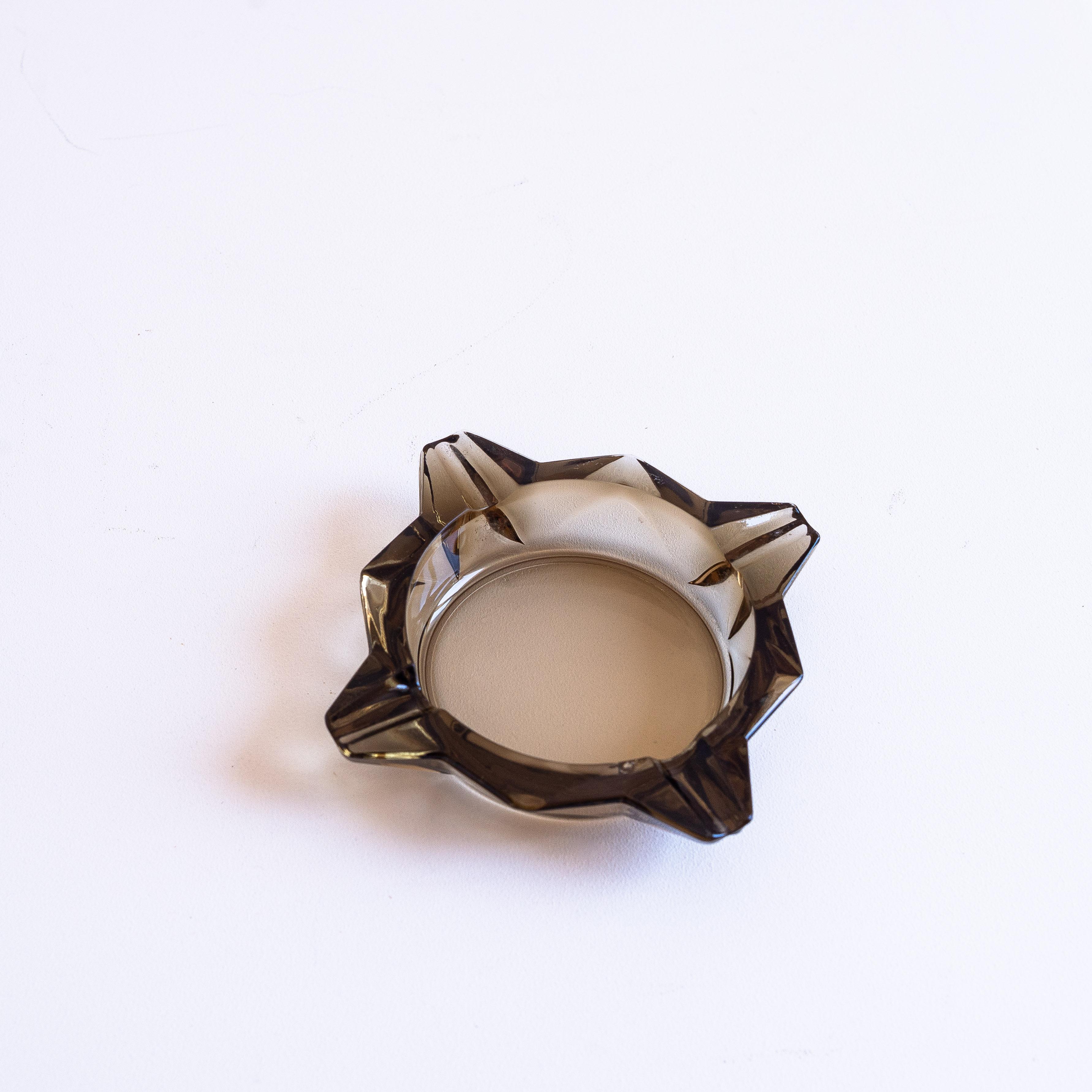 Smoked Glass Ashtray, Star Geometric Design, France 1970s

Typical design from the 1970s

Smoked glass with faceted work

Originally an ashtray, can be used as a small trinket or bowl for small objects (coins, rings, jewels etc).
