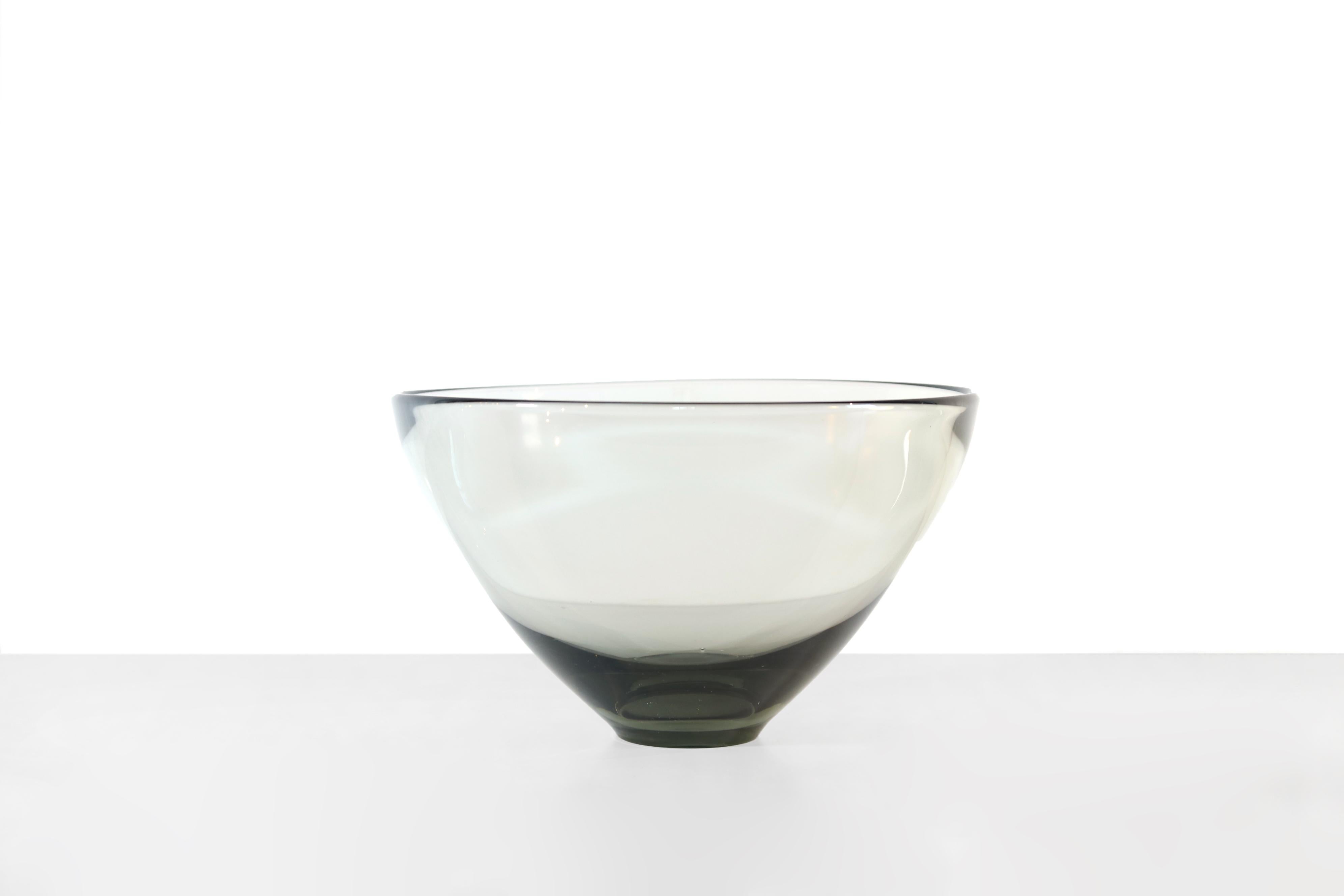 Beautifully designed glass bowl designed by Pet Lutken and made by Holmegaard in the 1960s in Denmark. This bowl is handmade and stick-blown from gray-brown smoked glass with a beautiful heavy bulb bottom. The bowl is marked and can also be seen in
