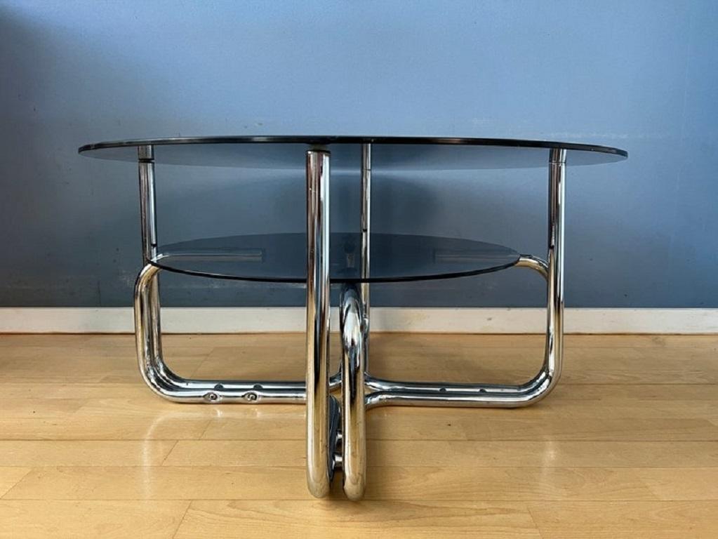 Chrome space age coffee table with two smoked glass surfaces. The piece has a higher and lower level. The smoked glass has a transparant gray colour.

Additional information:
Period: 1970s
Dimensions: Width: 130 cm
Height: 56 cm
Depth: 130