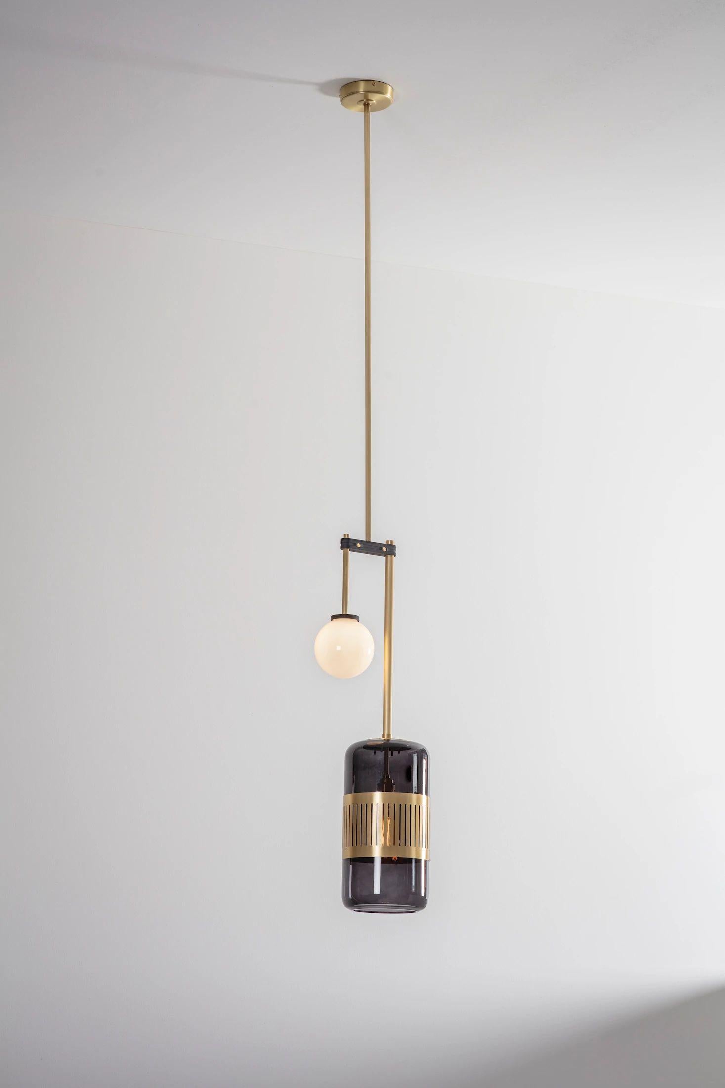 Smoked glass lizak drop pendant by Bert Frank.
Dimensions: D 78 x W 27 x H 78 cm
Materials: brass and glass.

Available finishes: brass, opal and blue.
All our lamps can be wired according to each country. If sold to the USA it will be wired