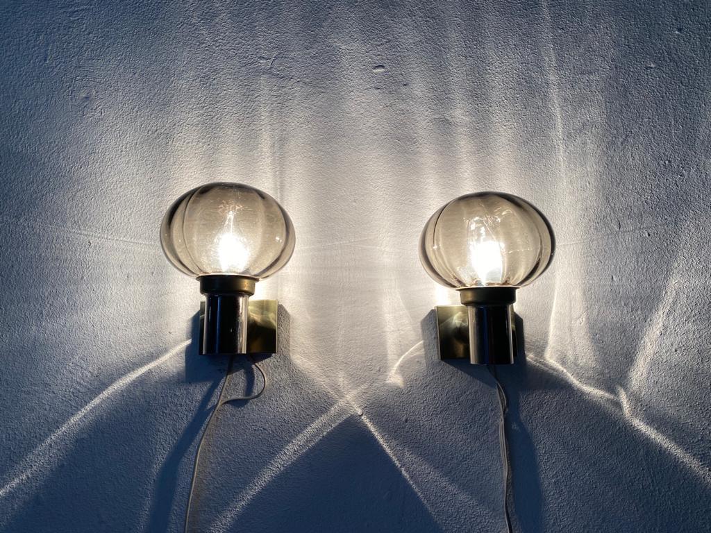 Smoked glass pair of wall lamps by N Leuchten , 1960s Germany

Elegant rare high quality wall lamps.

Lamps are in very good vintage condition.
Wear consistent with age and use

These lamps works with E14 standard light bulbs. 
Wired and