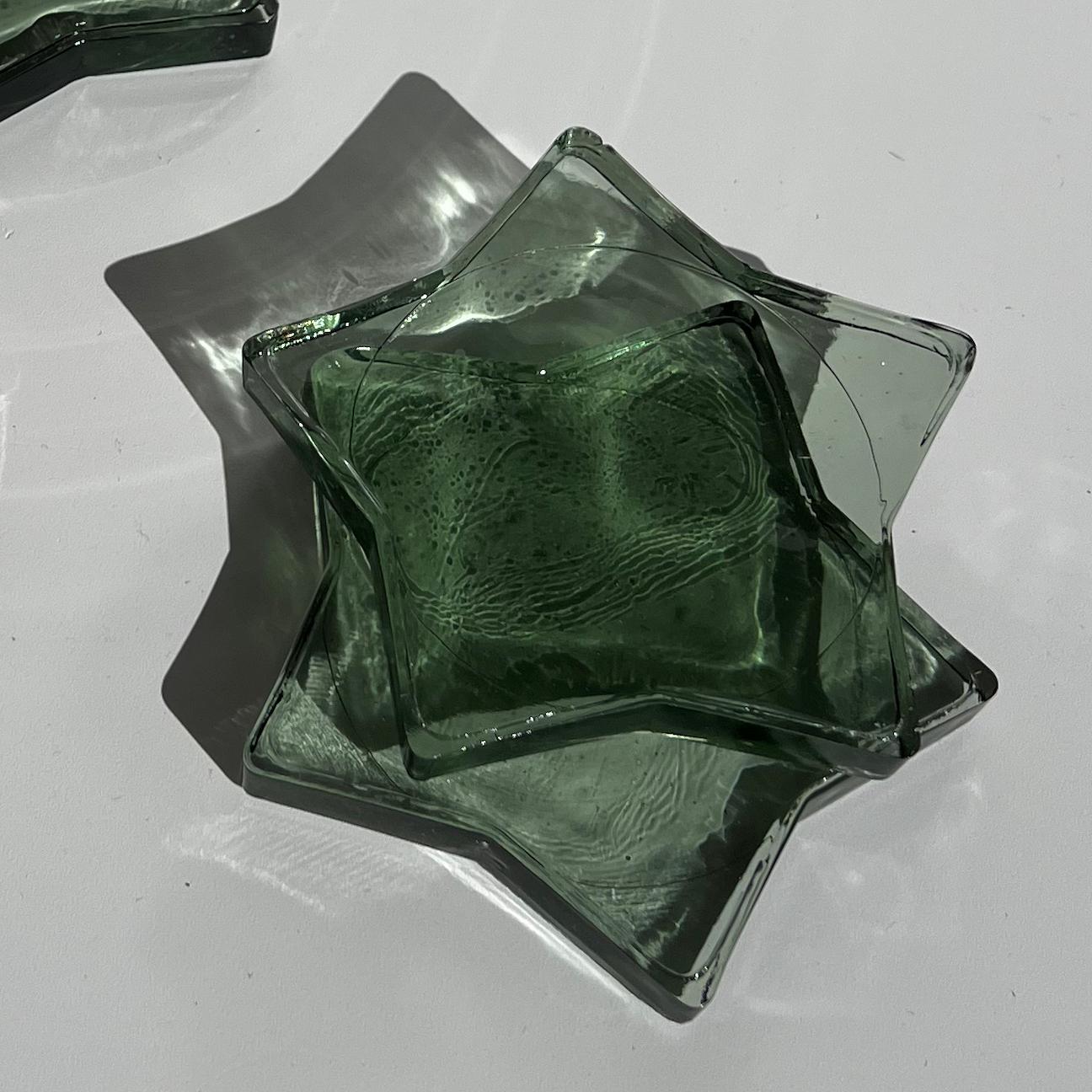 Add a touch of whimsy to your tabletop with this set of 4 smoked glass star coasters. These coasters feature a unique star shape design and a smoked finish that gives them a timeless look. Perfect for protecting surfaces from water damage, these