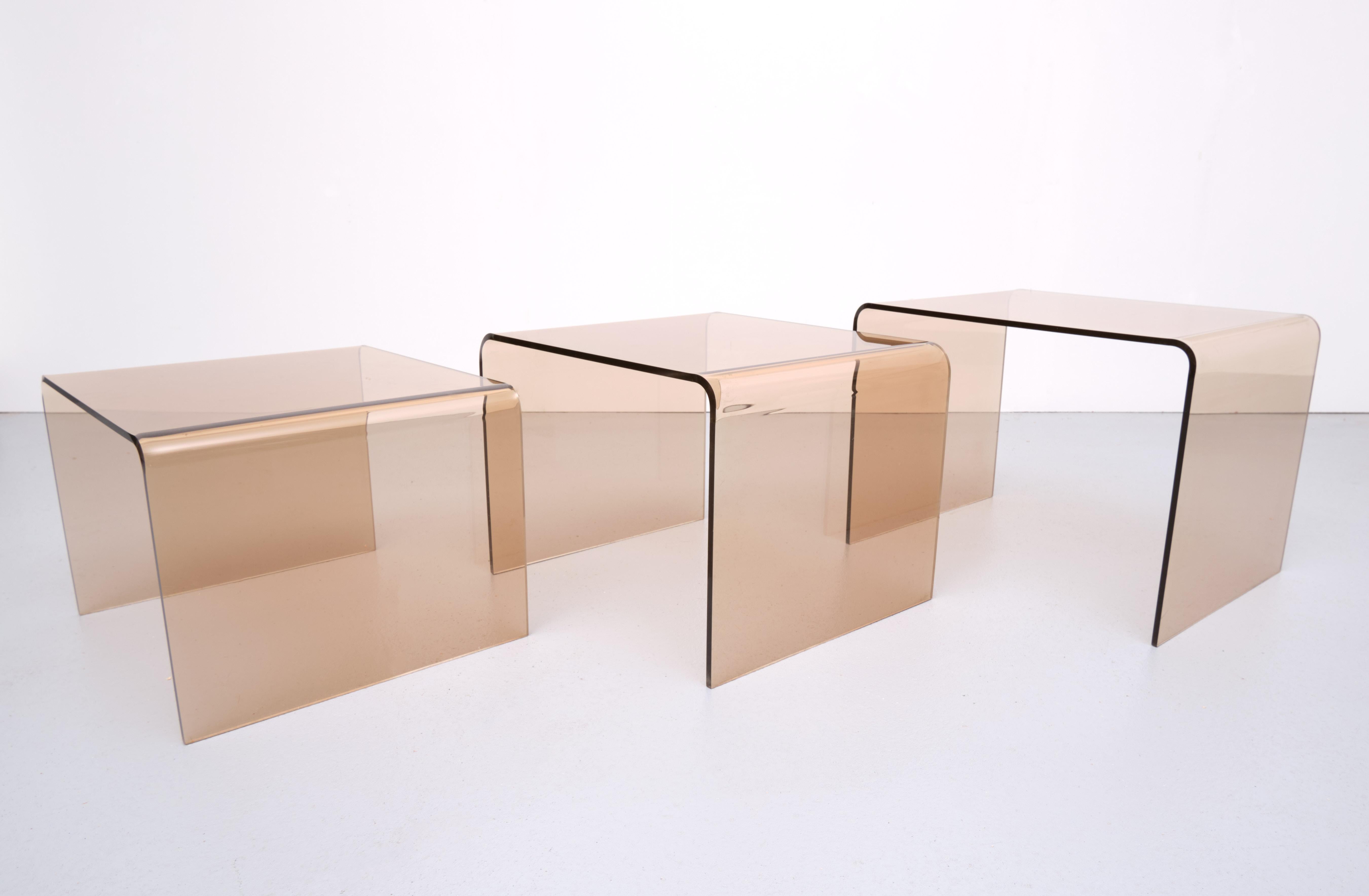 Set of three Lucite nesting tables. Smoked brown color. 1970s France 
Good condition. 
Large height 36.5 cm width 49 cm depth 39.5 cm
Middle height 34 cm width 45 cm depth 39.5 cm
Small height 30.5 cm width 41 cm depth 39.5 cm.