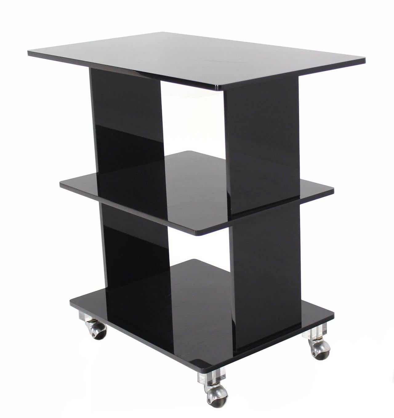 Mid century modern dark lucite serving rolling table mini etagere bookcase on wheels.