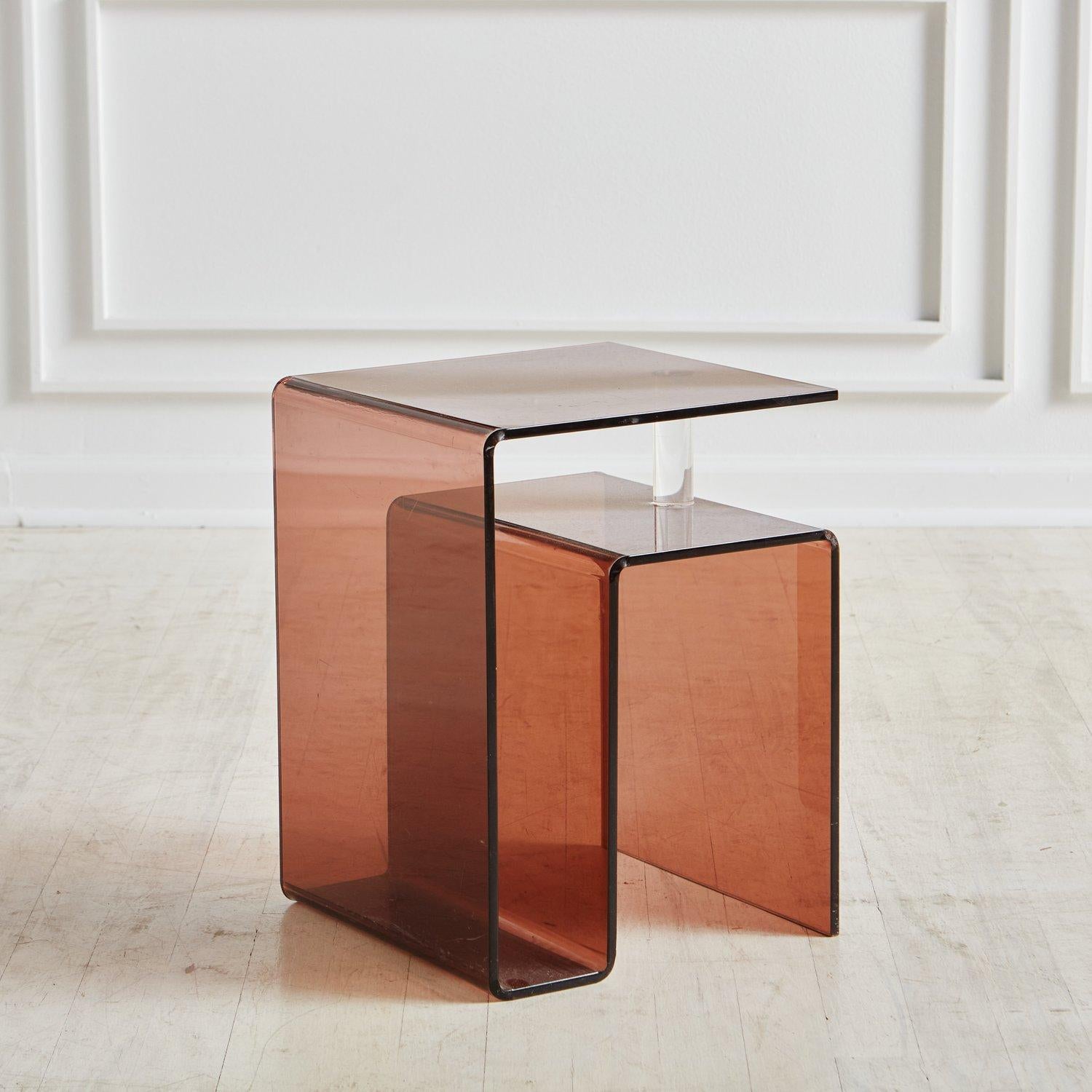 A smoked plexiglass side table attributed to French painter and designer Michel Dumas for Roche Bobois in the 1970s. This rare model features a sculptural frame with a subtle clear lucite detail for added support. This table is unsigned.