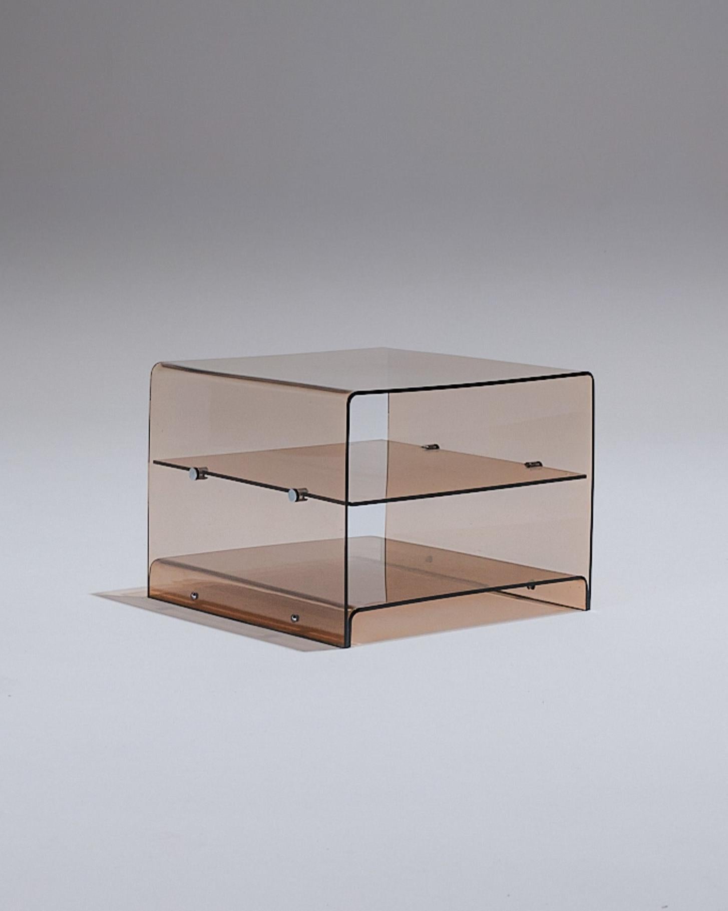 Vintage smoked plexiglass side table, designed by Michel Dumas for Roche Bobois in the 1970s.
Featuring two practical shelves, its sleek and lightweight design reflects the aesthetic of the era. Very good vintage condition, with a natural
