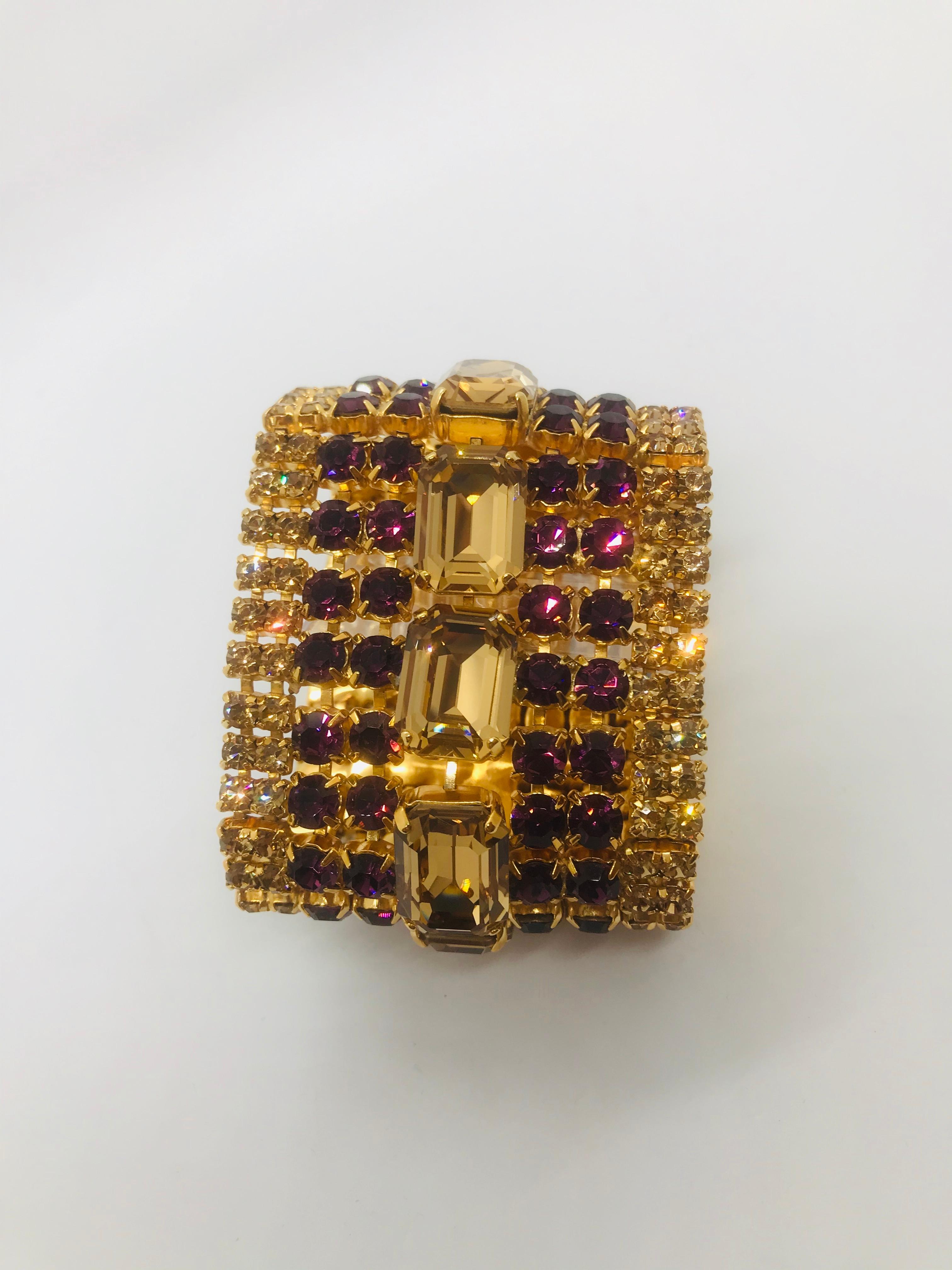 Classic and clean lines best describe our smoked topaz and amethyst Austrian crystal flex cuff bracelet.  This bracelet features a row of large emerald cut light Colorado topaz Swarovski contemporary crystals running end to end.  The bracelet is