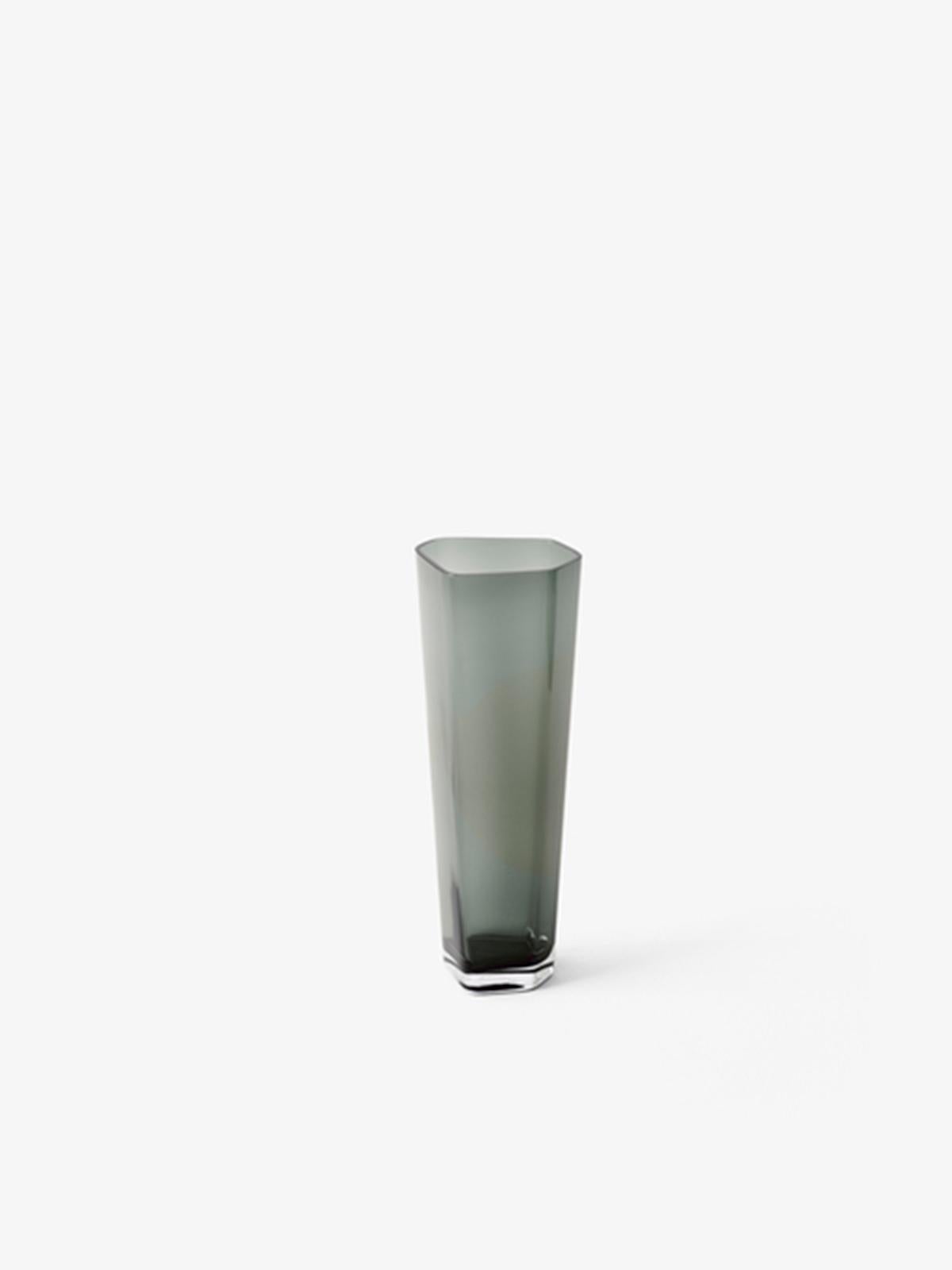 Designed by Space Copenhagen, this Smoked vase sits within the Collect series, a curated line of beautifully crafted soft furnishings and home objects.
Each vase is uniquely made from mouth blown glass in a fixed mould, which ensures the curved