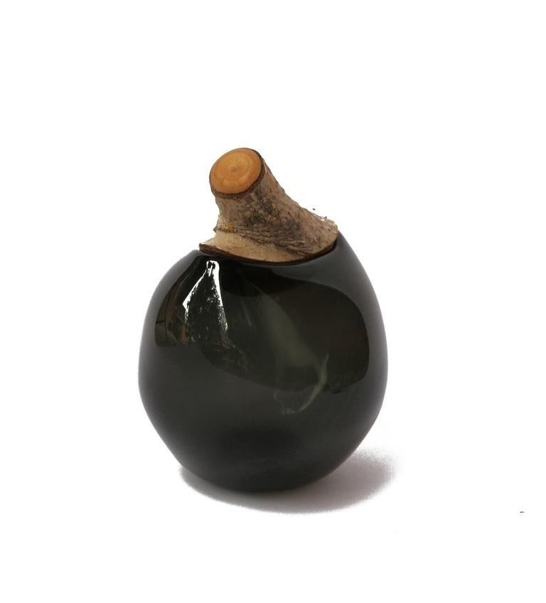 Smokey branch bowl, Pia Wüstenberg
Dimensions: D 16-18 x H 20
Materials: glass, wood
Available in other colors.

A playful jar, with a lid made from a branch stub following the curvature of the glass. Branch Bowls are blown without a mould: