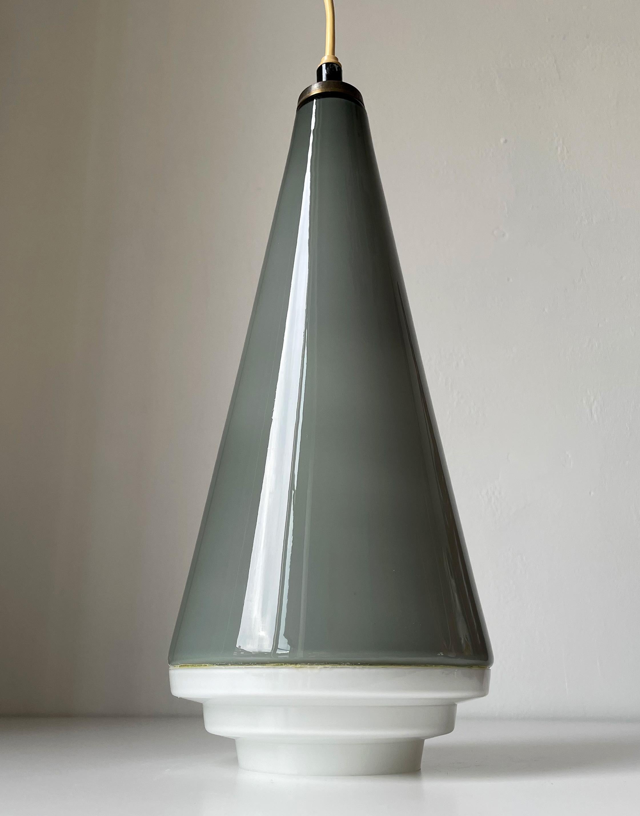 Plafonnier en verre conique de style européen des années 1950. Grande suspension conique en verre gris fumé chaud sur fond blanc avec base en verre blanc de style art déco. Raccord d'origine pour ampoule E27. Câblage sur demande. Belle condition