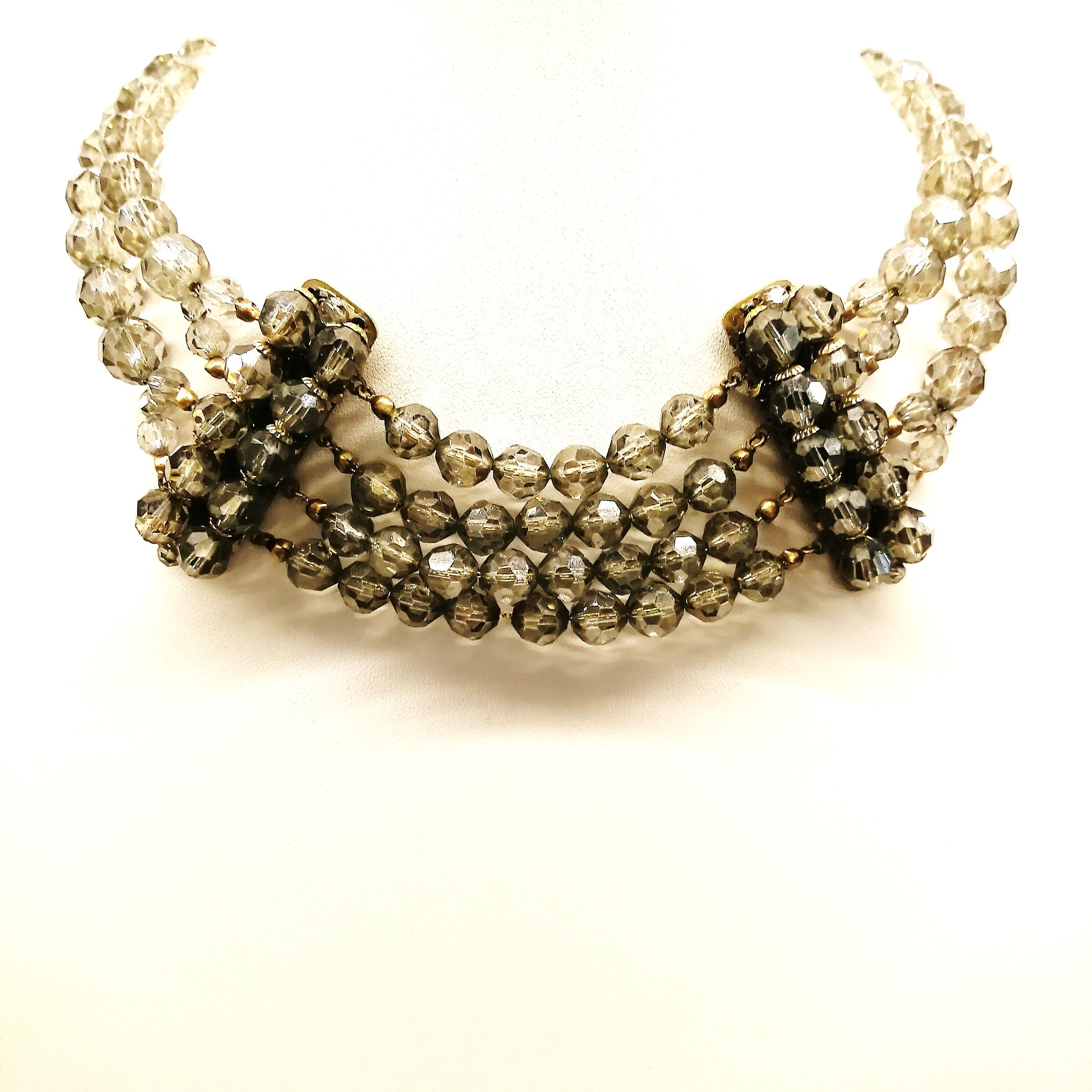 A stylish choker necklace from the celebrated designers/manufacturers Coppola e Toppo, from the late 1940s/early 1950s, in a very subtle but shimmering hue, of smokey grey. The cut and faceting of the beads gives this necklace an exceptional sparkle