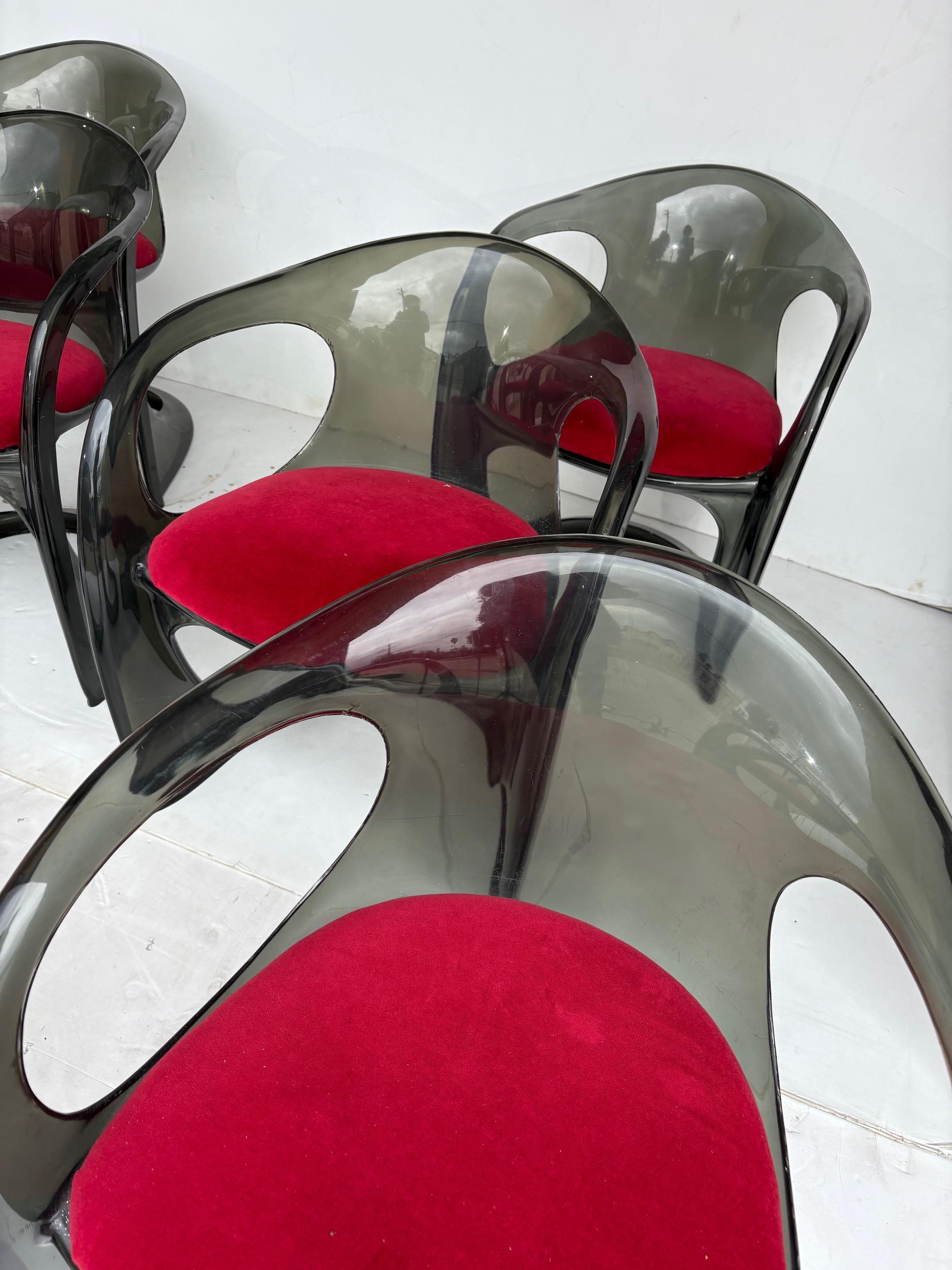 A set of smoky Lucite dining chairs. The chairs are sturdy, but there are scratches and nicks. 
