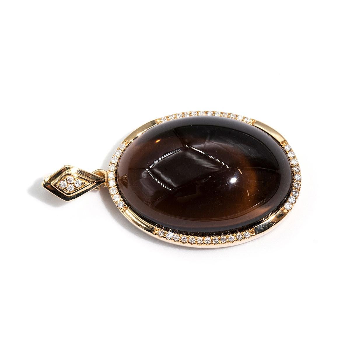 Carefully crafted in 9 carat yellow gold is this vintage inspired oval cabochon cut Smokey Quartz enhancer pendant.  Beset with sparkling round brilliant cut diamonds this unforgettable pendant is a work of art.  We have named this The Paisley