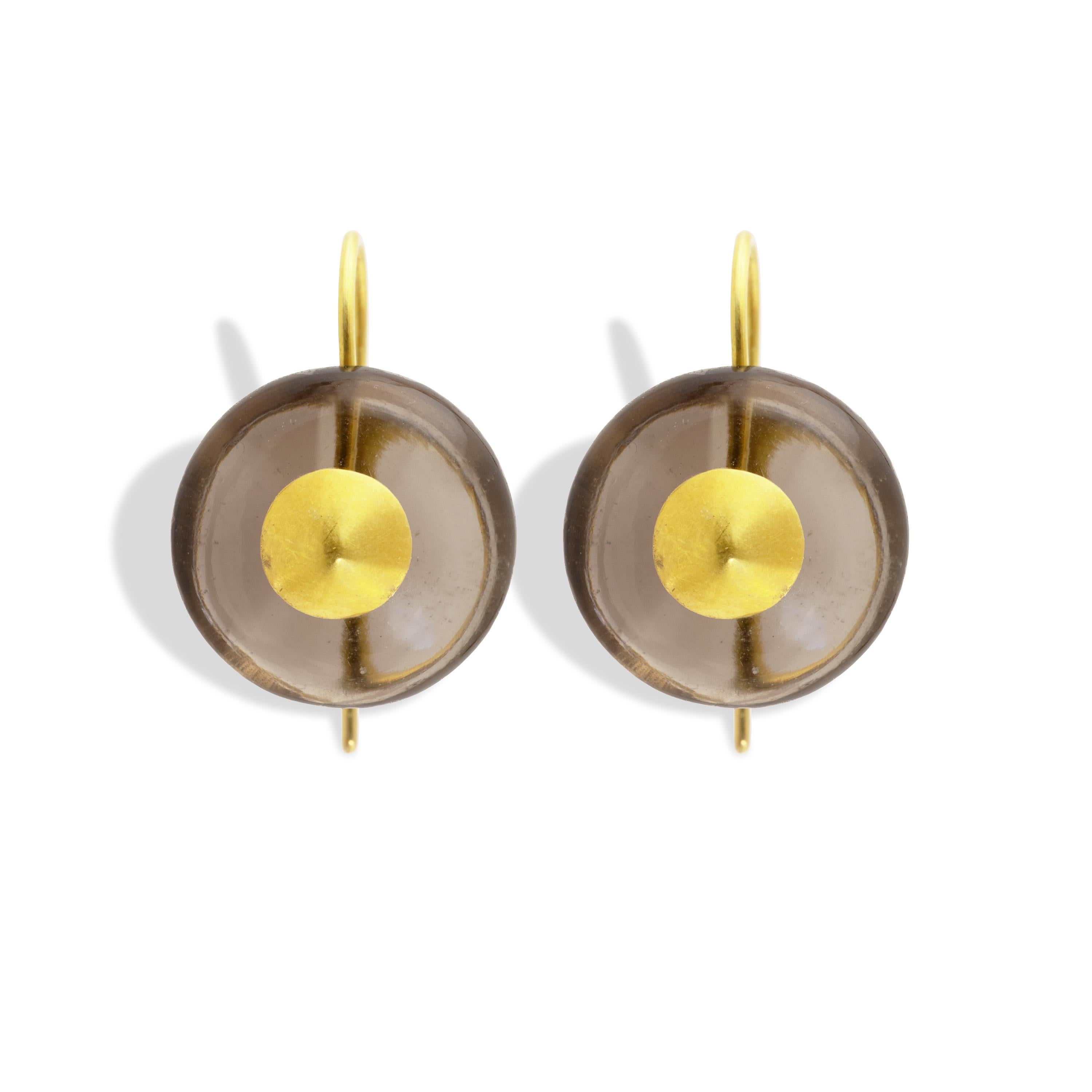 These chic modern button cabochon earrings feature 26 carats of smokey quartz set in 22k brushed gold.  The earrings measure 14mm in diameter and feature a 22k domed center. Simple and modern.

Smoky Quartz is known as a Stone of Power. To the