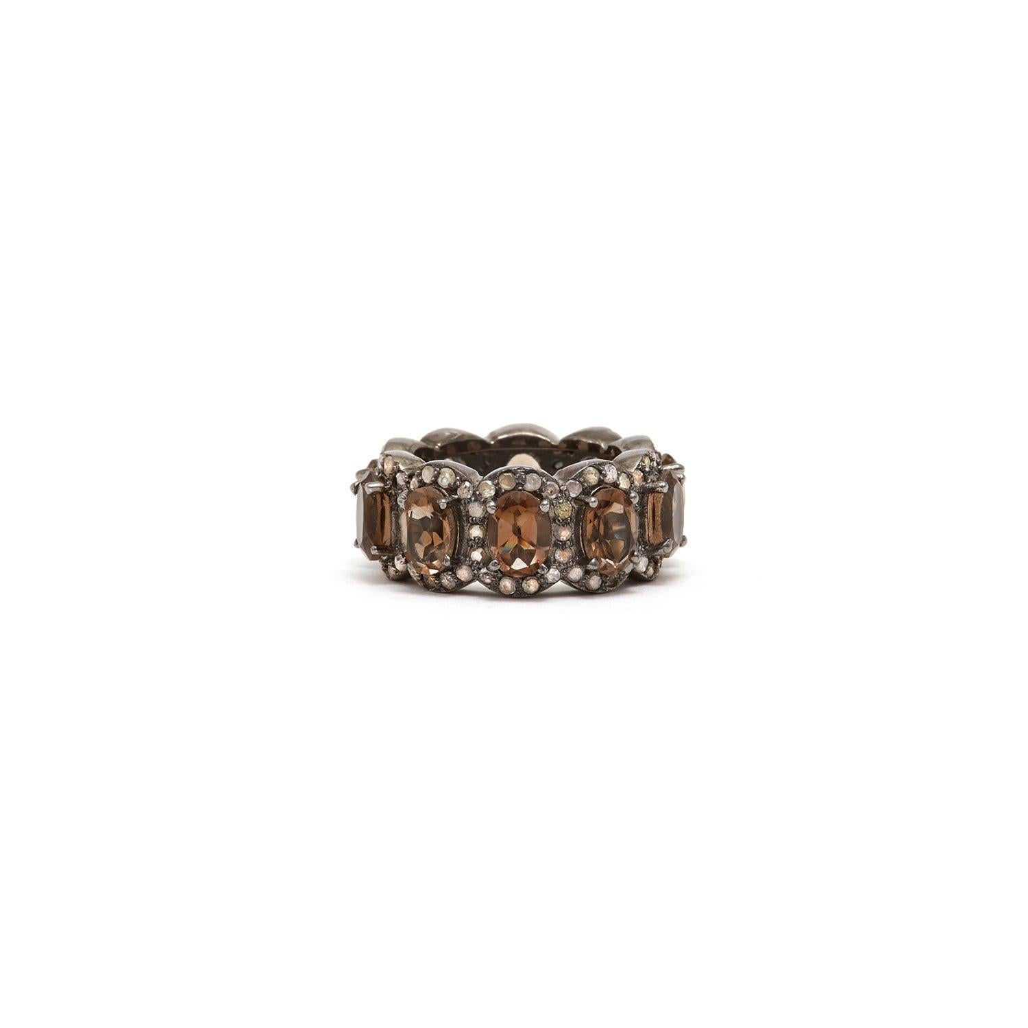 Chocolate smokey Quartz baguettes accented with white Diamonds in a blackened silver band reminiscent of an Art Deco Tiara.

- Natural Chocolate Smokey Quartz.
- Natural Diamonds.
- Set in Blackened Oxidized Silver.