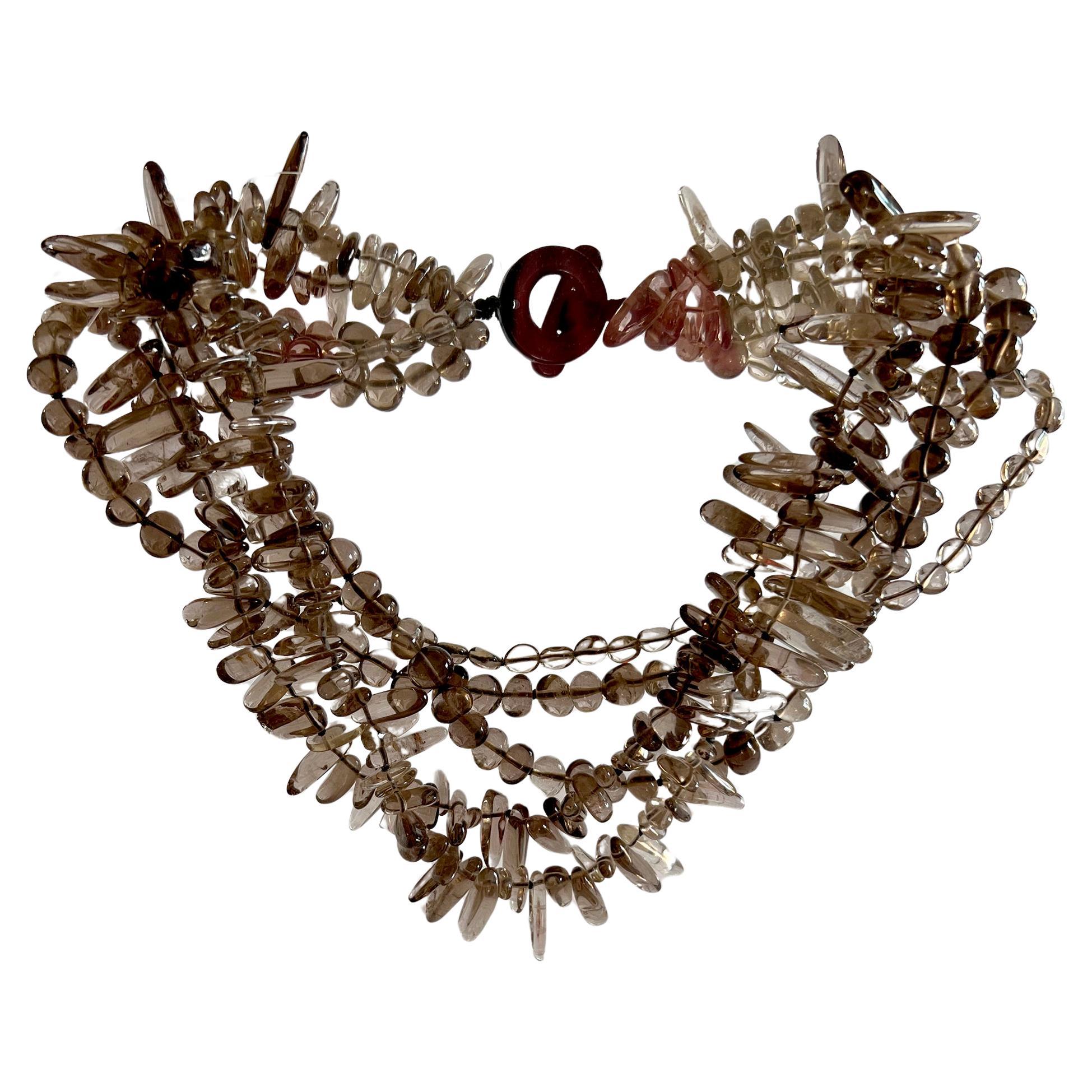 Five strands of hand strung natural cut and tumbled smokey quartz necklace, circa 1990's.  Necklace is very well made with resin clasp.  It measures 19