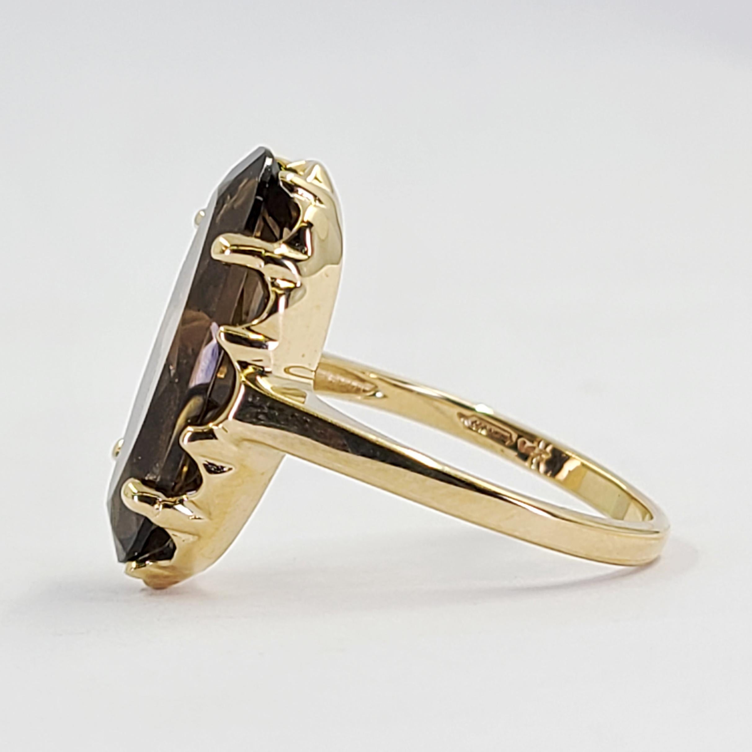 14 Karat Yellow Gold Cocktail Ring Featuring An Elongated 20mm x 10mm Oval Cut Smokey Quartz Weighing Approximately 6.60 Carats. Finger Size 7.75. Finished Weight Is 4.8 Grams.