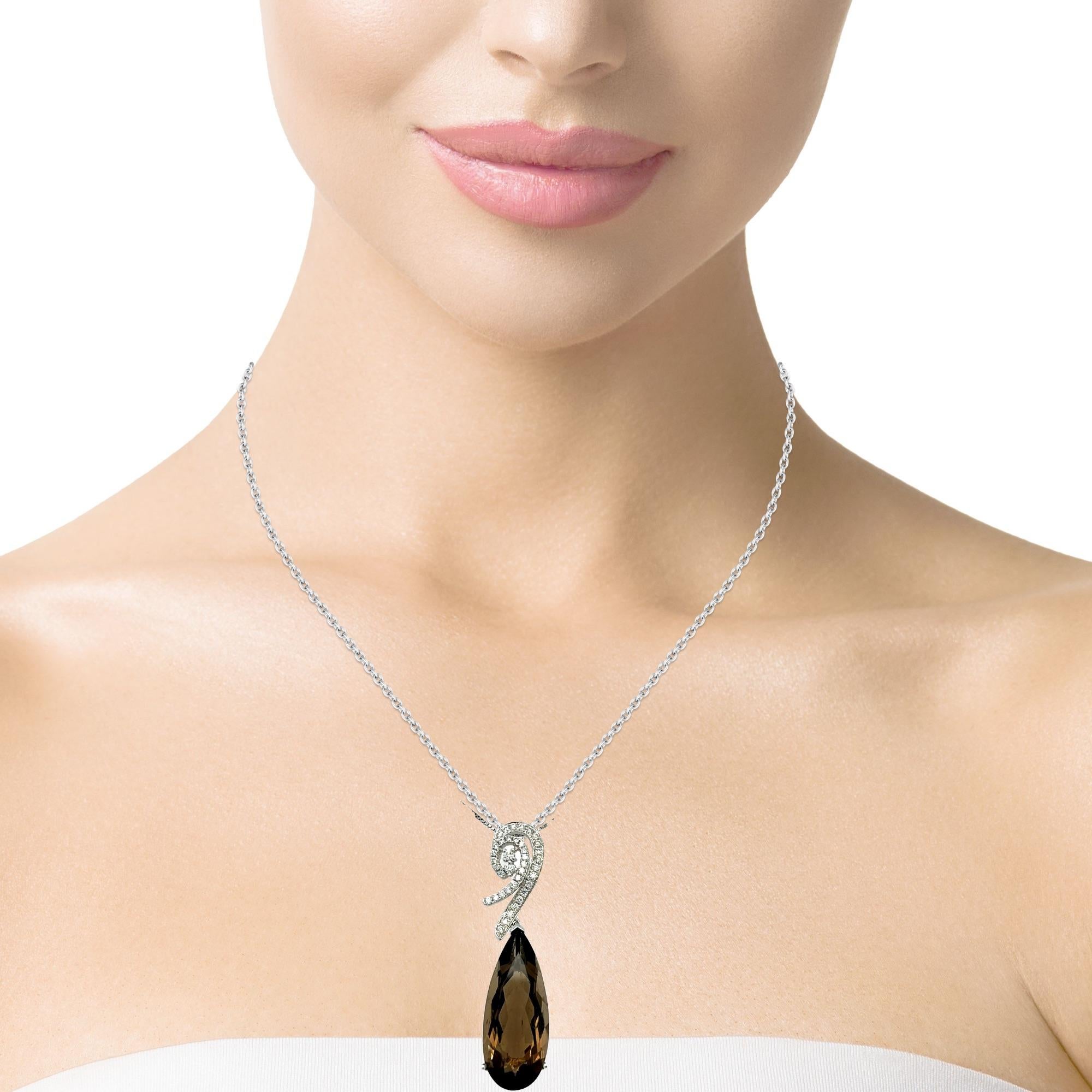 This stunning teardrop pendant has a top quality deep brown Smokey Topaz with a 3 prong setting in 14 karat white gold. There are 29 shimmering brilliant cut diamonds on top of the stone for a delicate accent. This pendant comes in a beautiful black