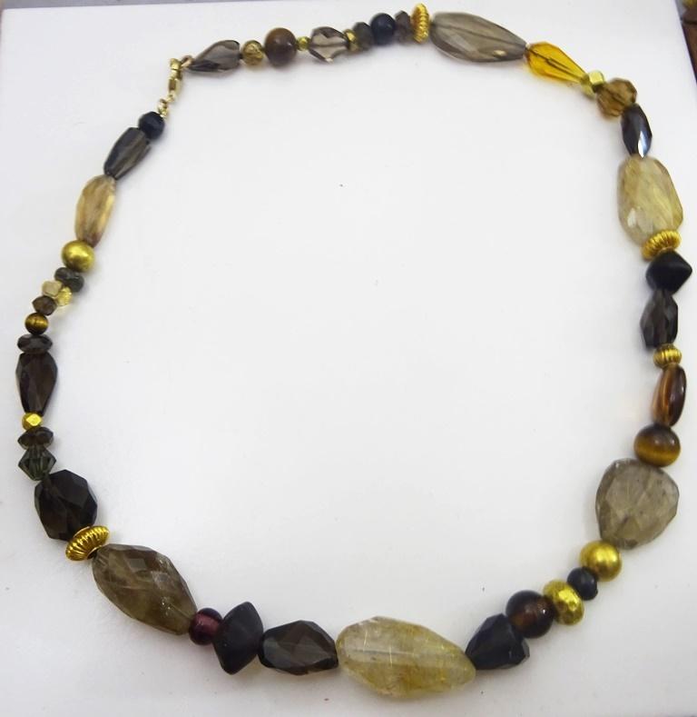 A Necklace creation from our Jerusalem workshop.
Onyx, Smokey Topaz ,  Gold  Ruttel  Quartz, Glass , Tiger Eye and Vintage 18 karat Gold Indian Beads.
In a elegant and classical composition, 
The Necklace is 21 inches long - 53 cm.
it can be