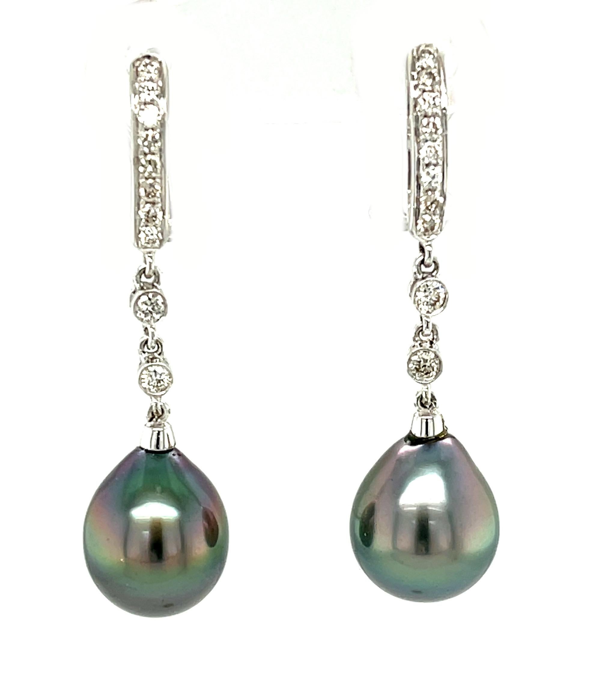 Grey pearl and diamond dangle earrings make a gorgeous statement! The pearls have a rich grey base color with pink and green overtones, and a high, almost metallic luster. These smooth pearls are suspended from an elegant line of tiny diamonds for a