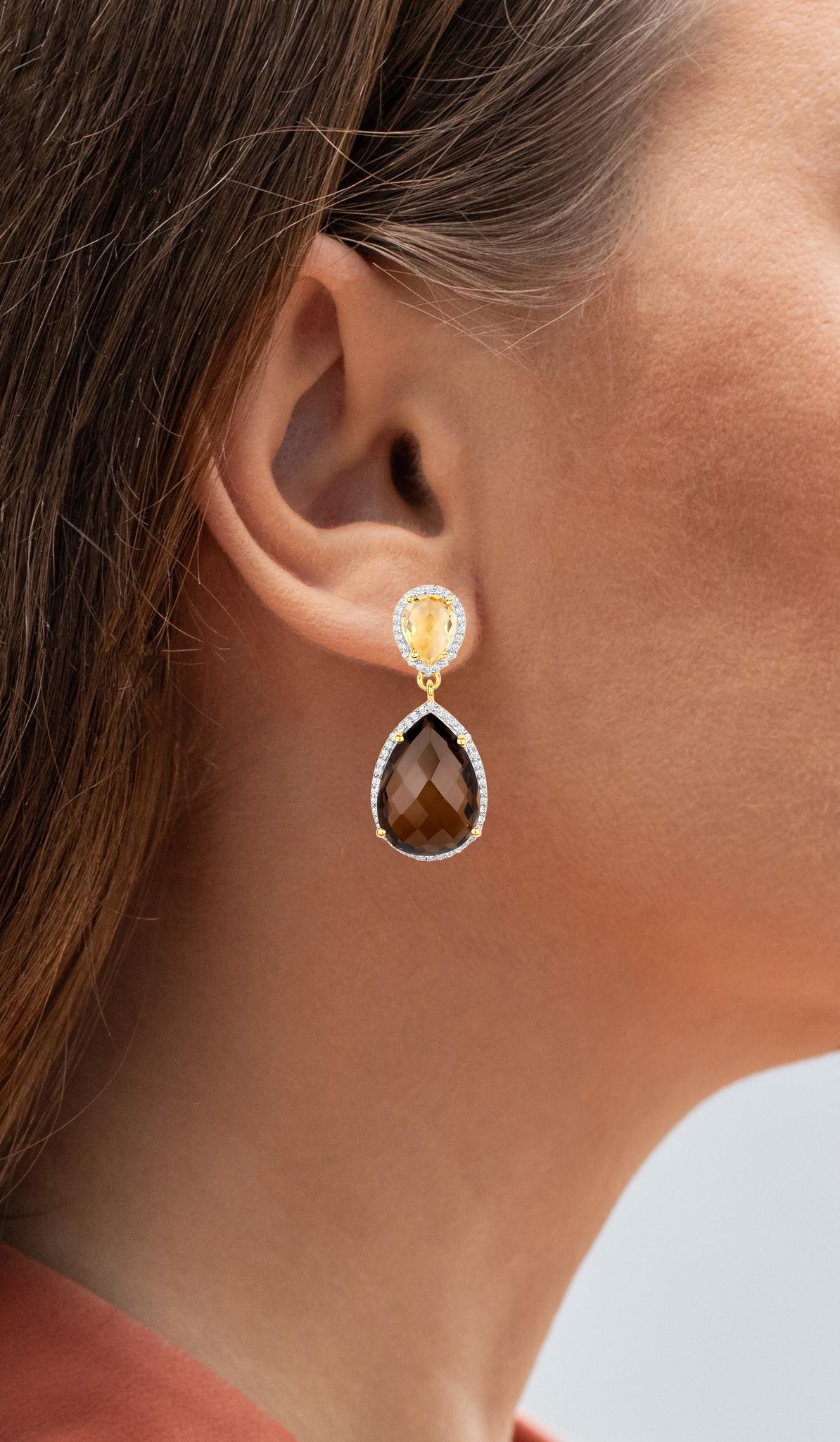 It comes with the Gemological Appraisal by GIA GG/AJP
All Gemstones are Natural
2 Smoky Quartz = 18.00 Carats
2 Citrines = 2.50 Carats
132 White Topazes = 0.66 Carats
Metal: 18K Yellow Gold Plated Sterling Silver
Dimensions: 35 x 15 mm
