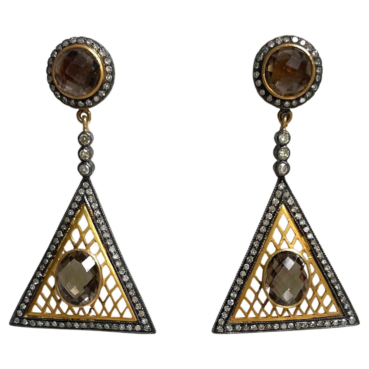 Description
Beauty, Power and Style are the affair of the heart of these dramatic earrings. The irresistible geometry of a triangle with the exquisite Smoky Quartz and diamonds add a sense of sparkle and elegance to your fashion statement mirroring