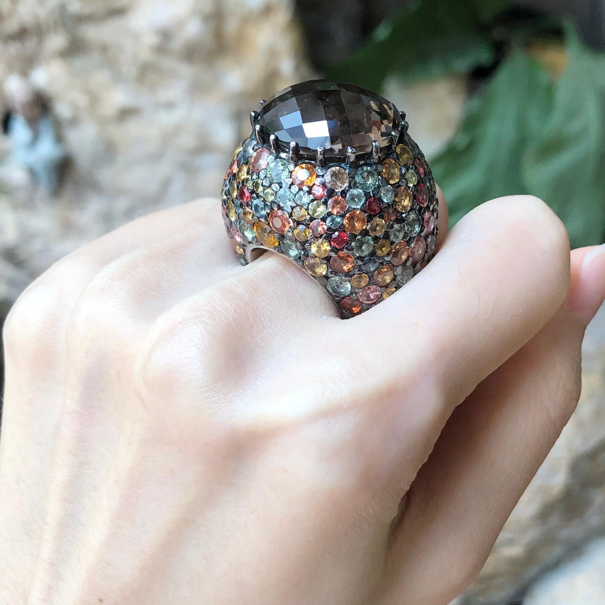 Smoky Quartz 30.0 carats and Rainbow Colour Sapphire 29.81 carats Ring set in Silver Settings

Width:  3.4 cm 
Length: 2.8 cm
Ring Size: 54
Total Weight: 47.76 grams

*Please note that the silver setting is plated with rhodium to promote shine and