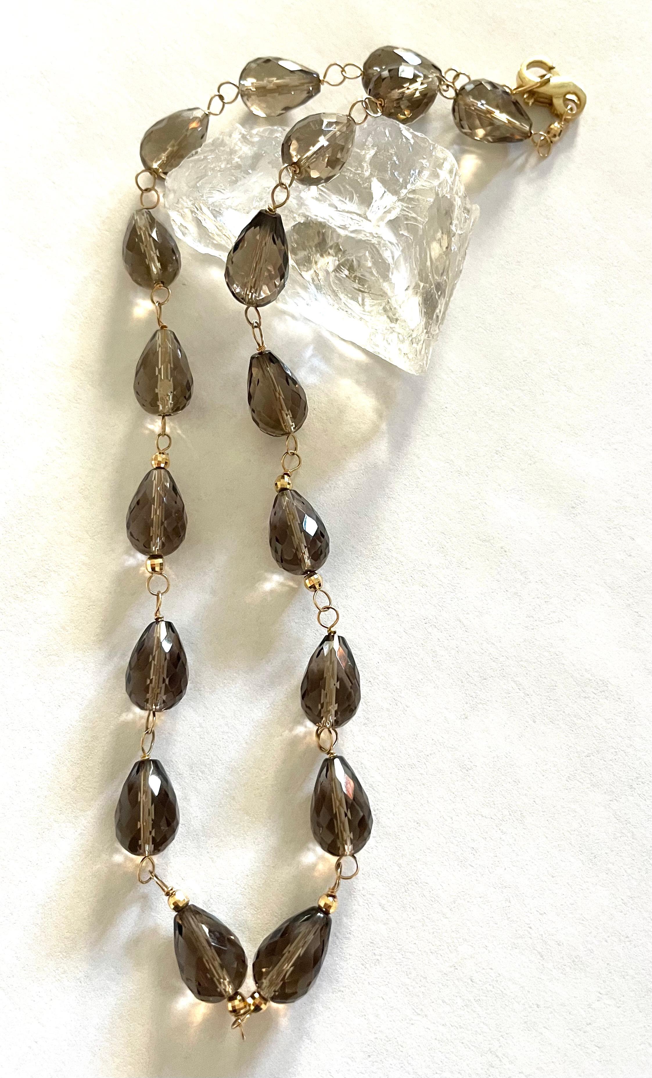 N3767 Smoky Quartz Necklace (correct content)
Description
Strikingly simple and feminine Smoky Quartz necklace with 14k yellow gold accents.
Item # N3767

Materials and Weight
Smoky quartz 9x13mm, 123cts, briolette shape
Faceted 3mm gold balls
14k