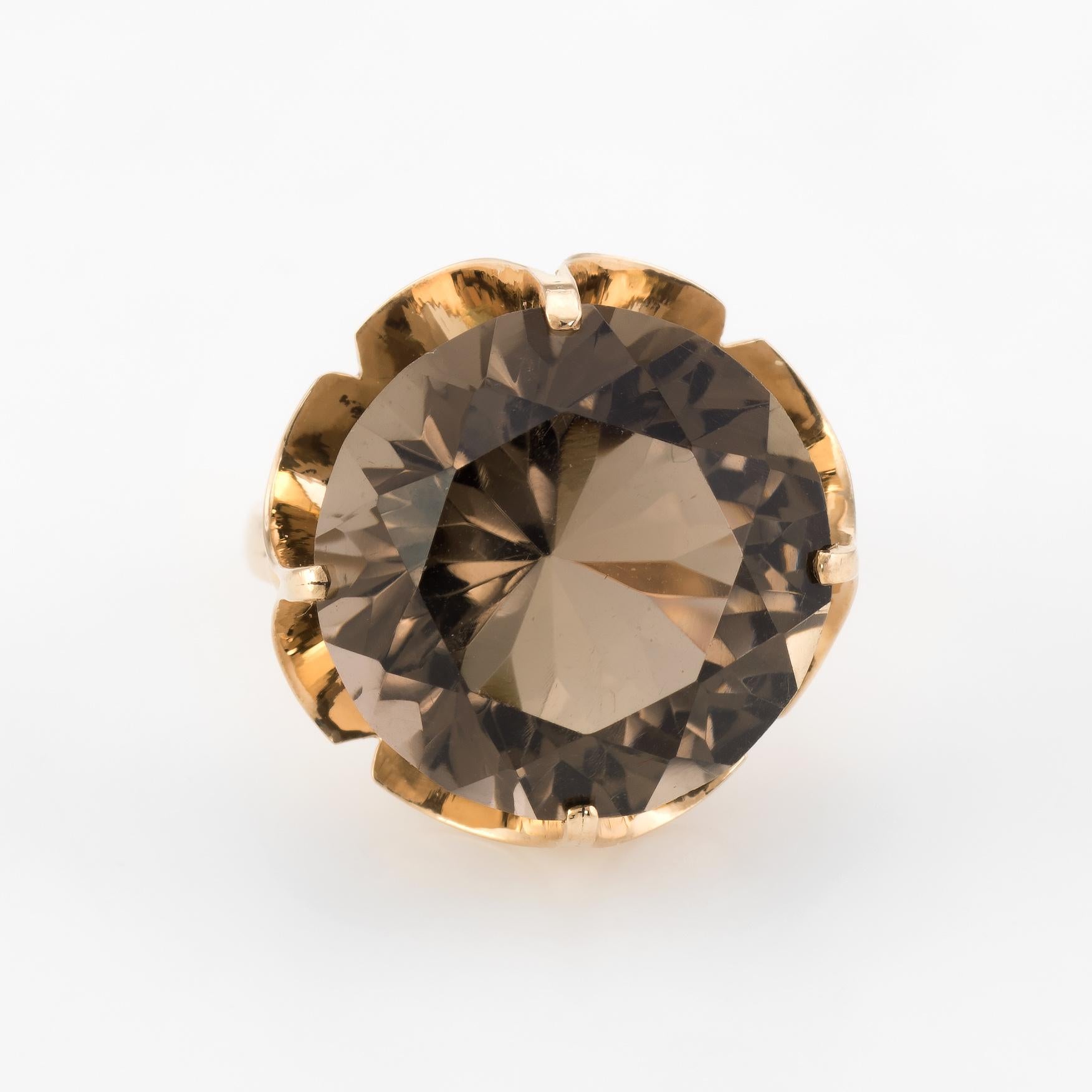 Finely detailed vintage statement cocktail ring (circa 1950s to 1960s), crafted in 14 karat yellow gold. 

Dramatic and bold details abound with a centrally mounted round faceted smoky quartz (topaz) measuring 16mm (estimated at 15.25 carats). The
