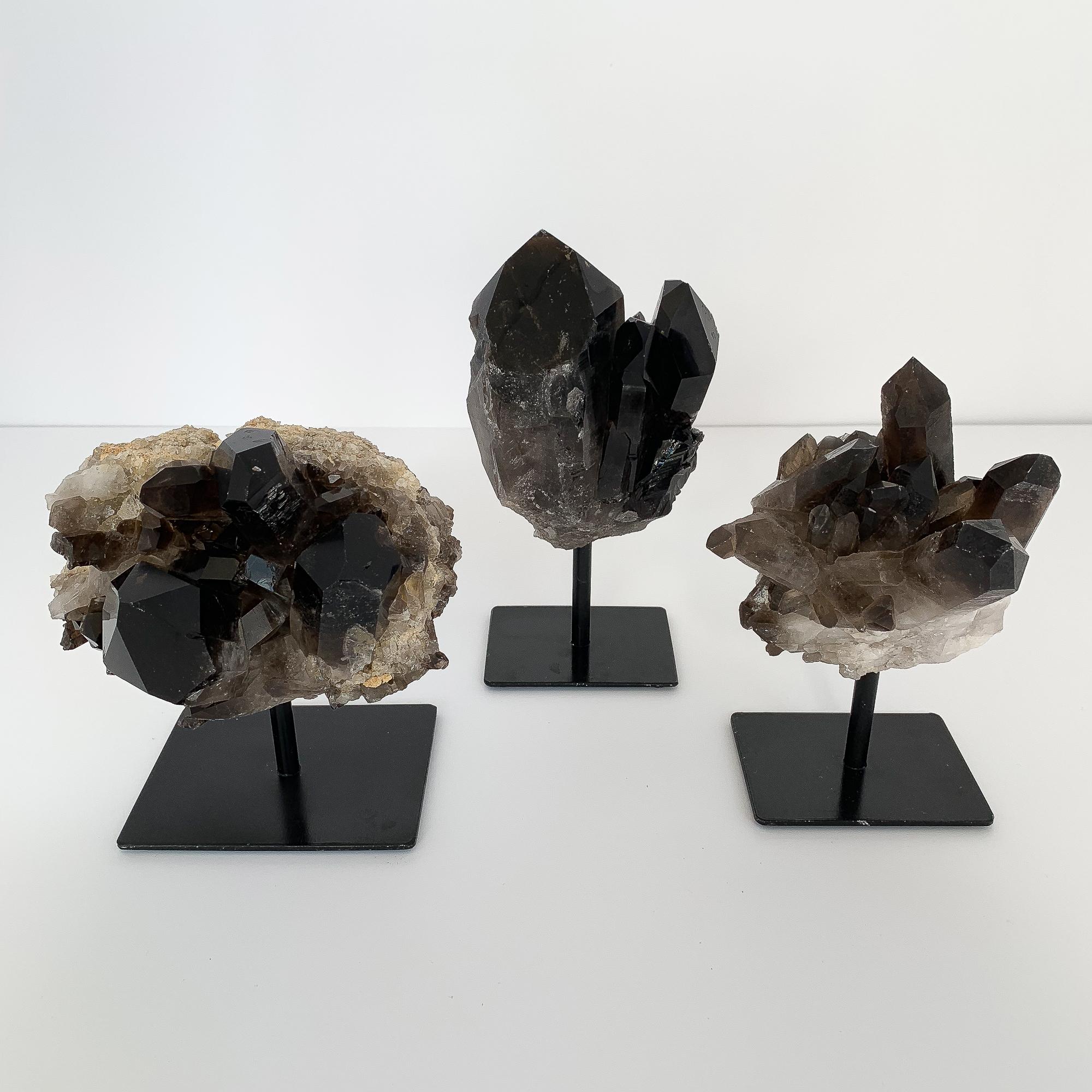 Natural smoky quartz crystal specimens mounted to painted black metal stands. Sold individually. Please state which crystal you would like to purchase:

Measures: Left - 7.5