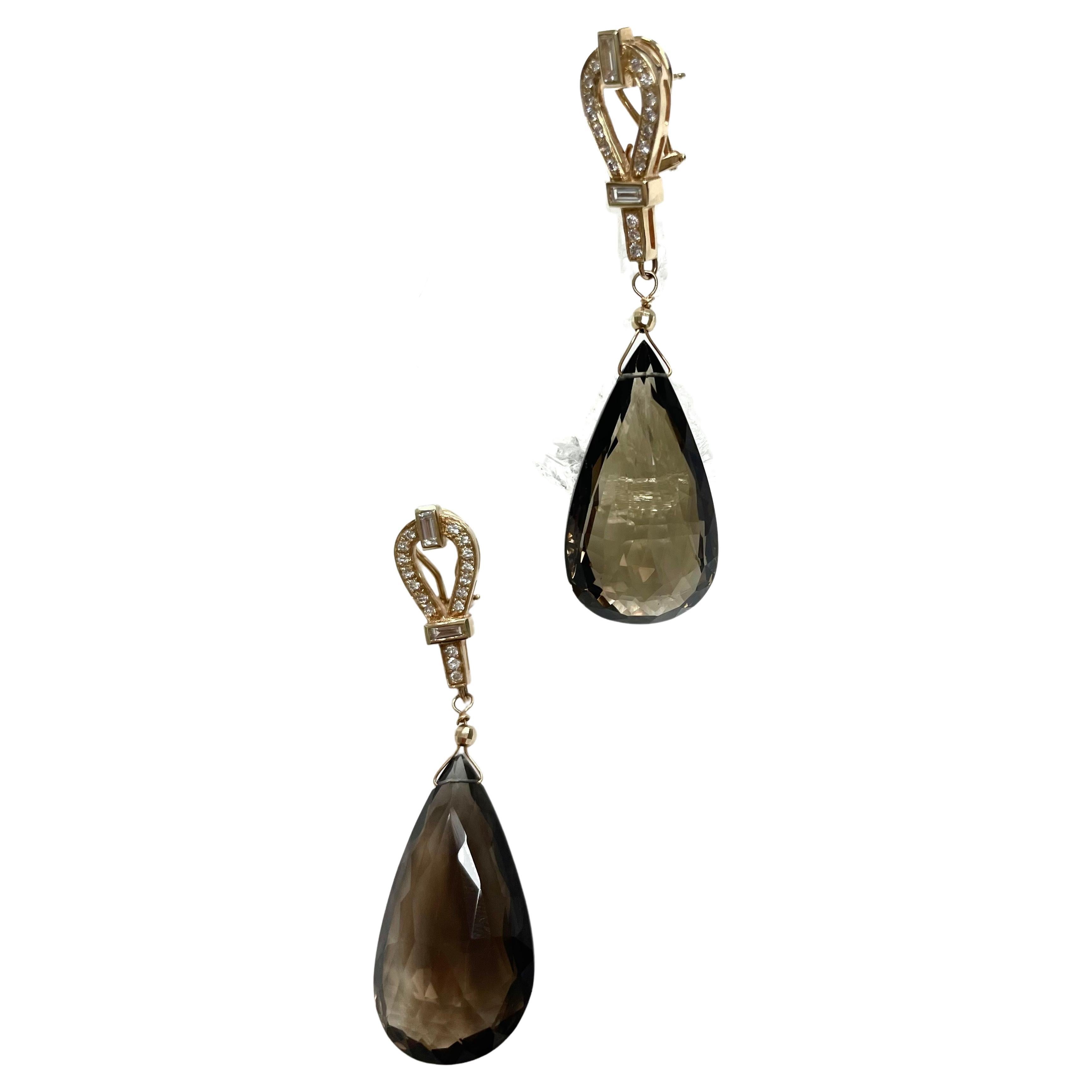 Description
Exquisite, dramatically large, faceted pear shape drops, suspended from an elegant 14k yellow gold pave and baguette diamonds omega back earrings.
Item # E3223
Check out matching necklace (see photo), Item # N3759

Materials and