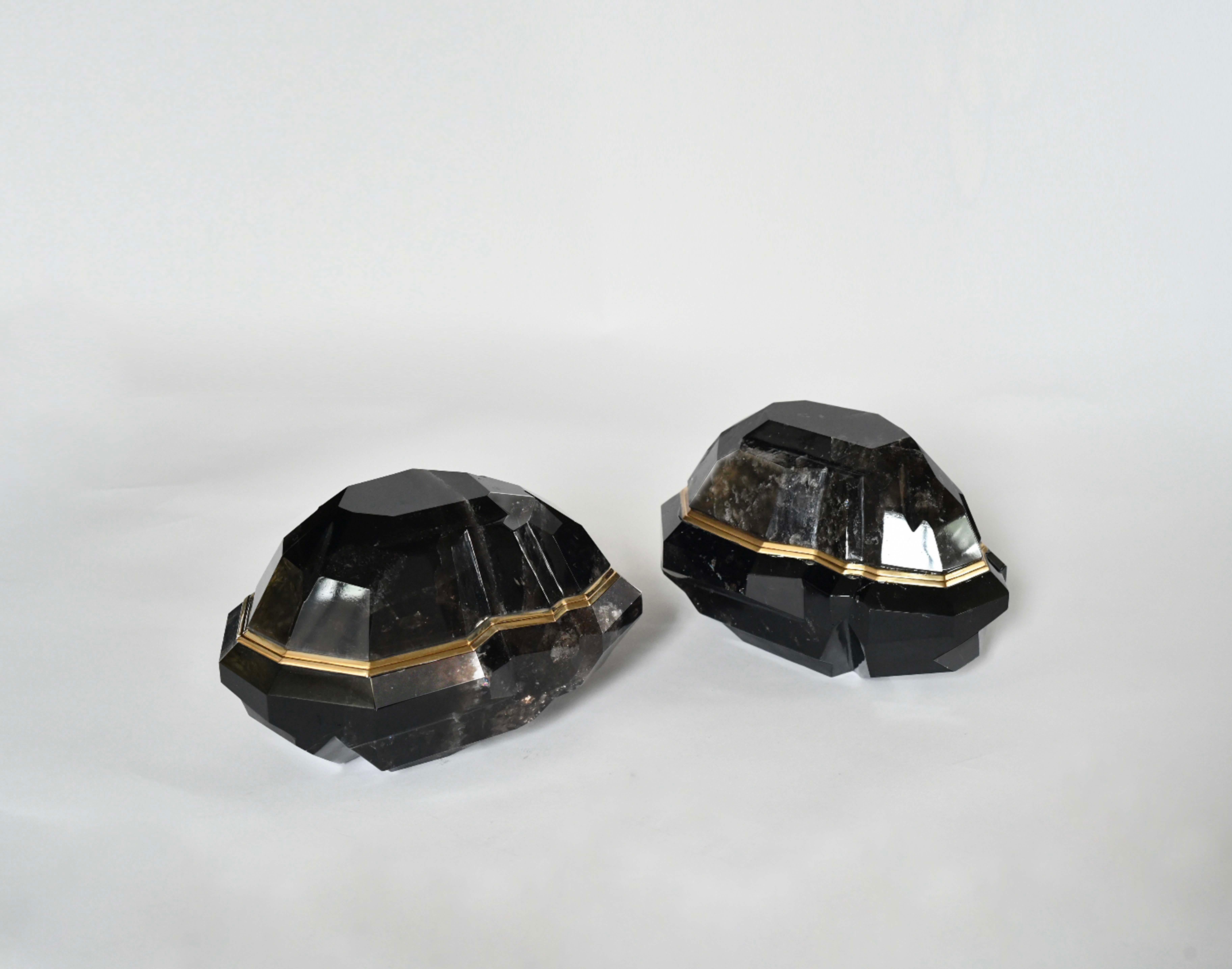 Group of two fine carved faceted dark smoky rock crystal boxes with brass decoration. Created by Phoenix Gallery, NYC.
 Both boxes are the same dimensions: 5