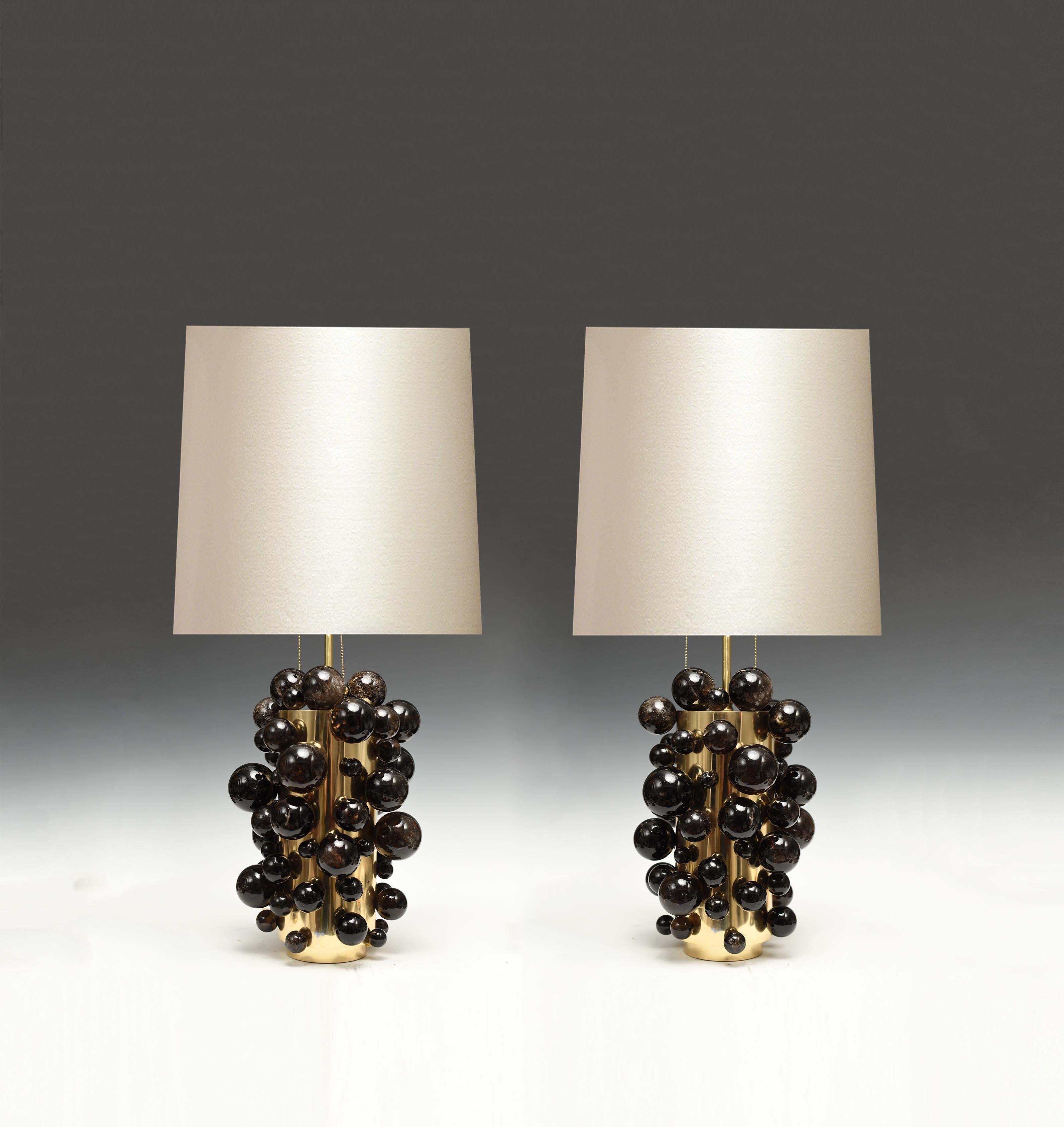 Pair of luxury dark rock crystal quartz bulb lamps with polished brass frames. Created by Phoenix Gallery, NYC.
Each lamp installed two sockets.
To the top of the rock crystal 17 inch.
Lampshade not included.
 