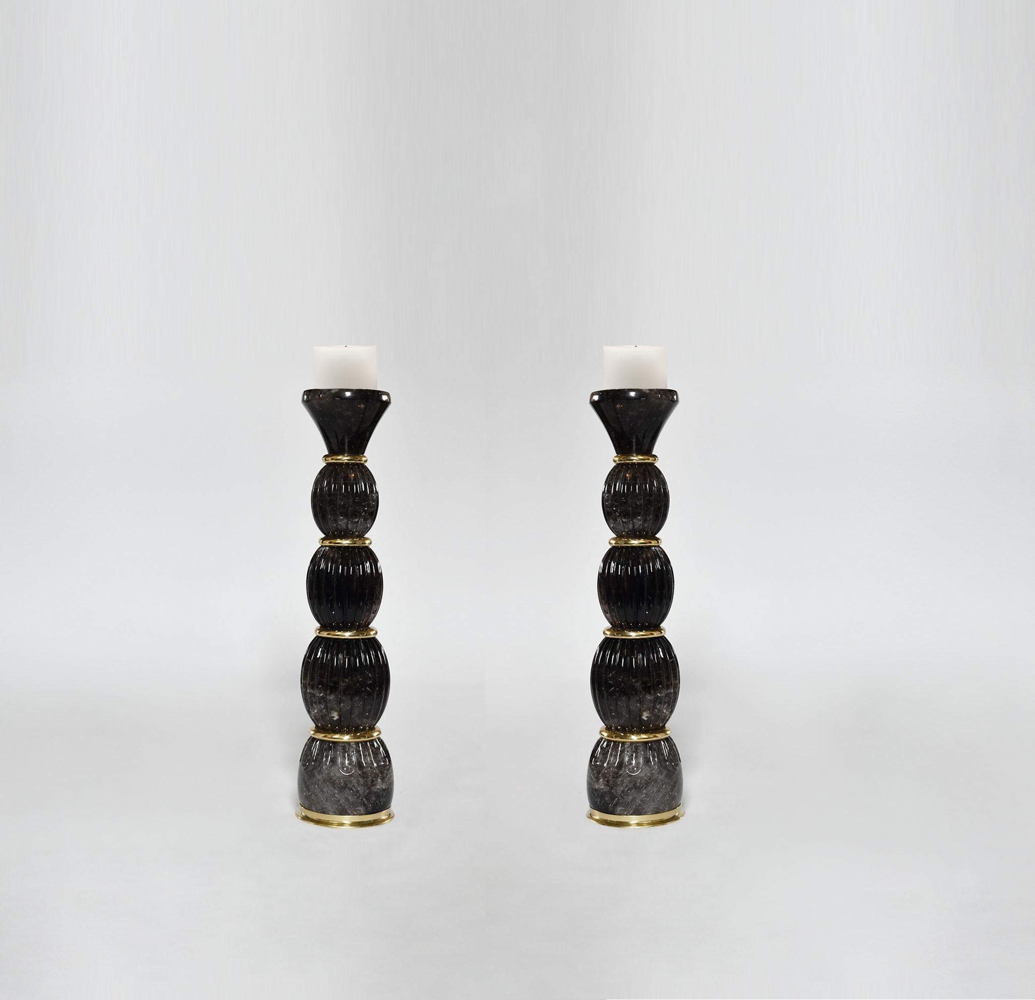 Pair of fine carved smoky rock crystal candleholders with polish brass insert decoration. Created by Pheonix Gallery, NYC.
Custom size and quantity upon request.