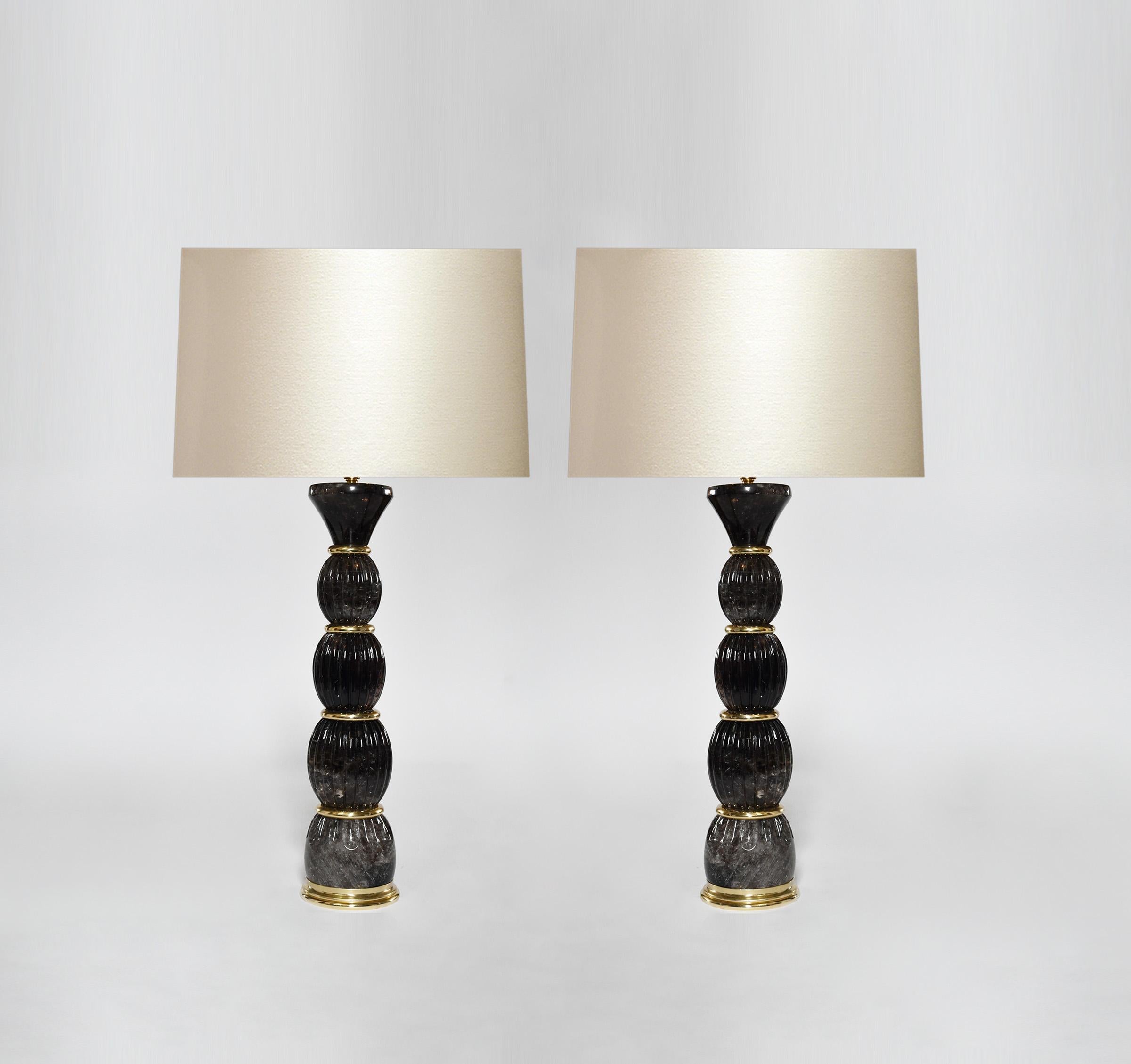 Pair of smoky rock crystal lamps with polish brass insert decoration. Created by Pheonix Gallery, NYC.
To the top of the rock crystal is 17 in.
(Lampshade not included).
Custom size and metal finish upon request.
