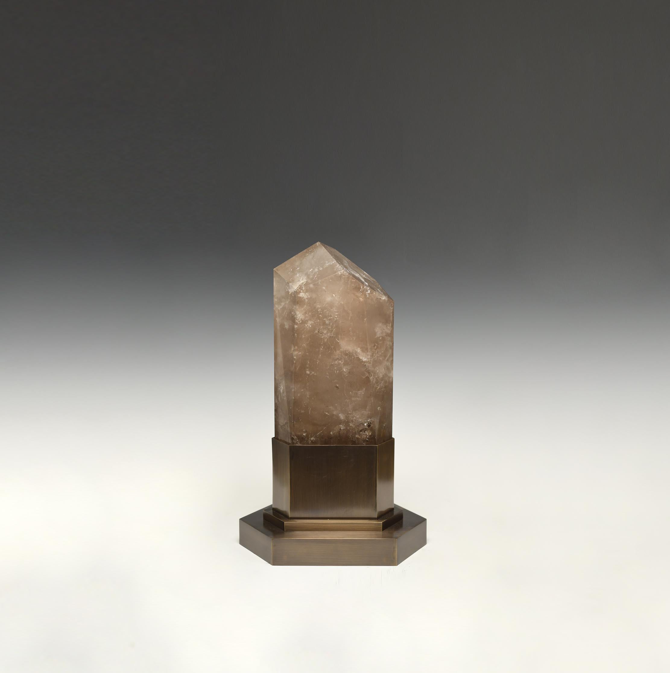 A smoky rock crystal obelisk light with an antique brass base. Created by Phoenix Gallery, NYC. 
Two sockets installed. Supply two led warm lights. 120w max.
Custom size available.