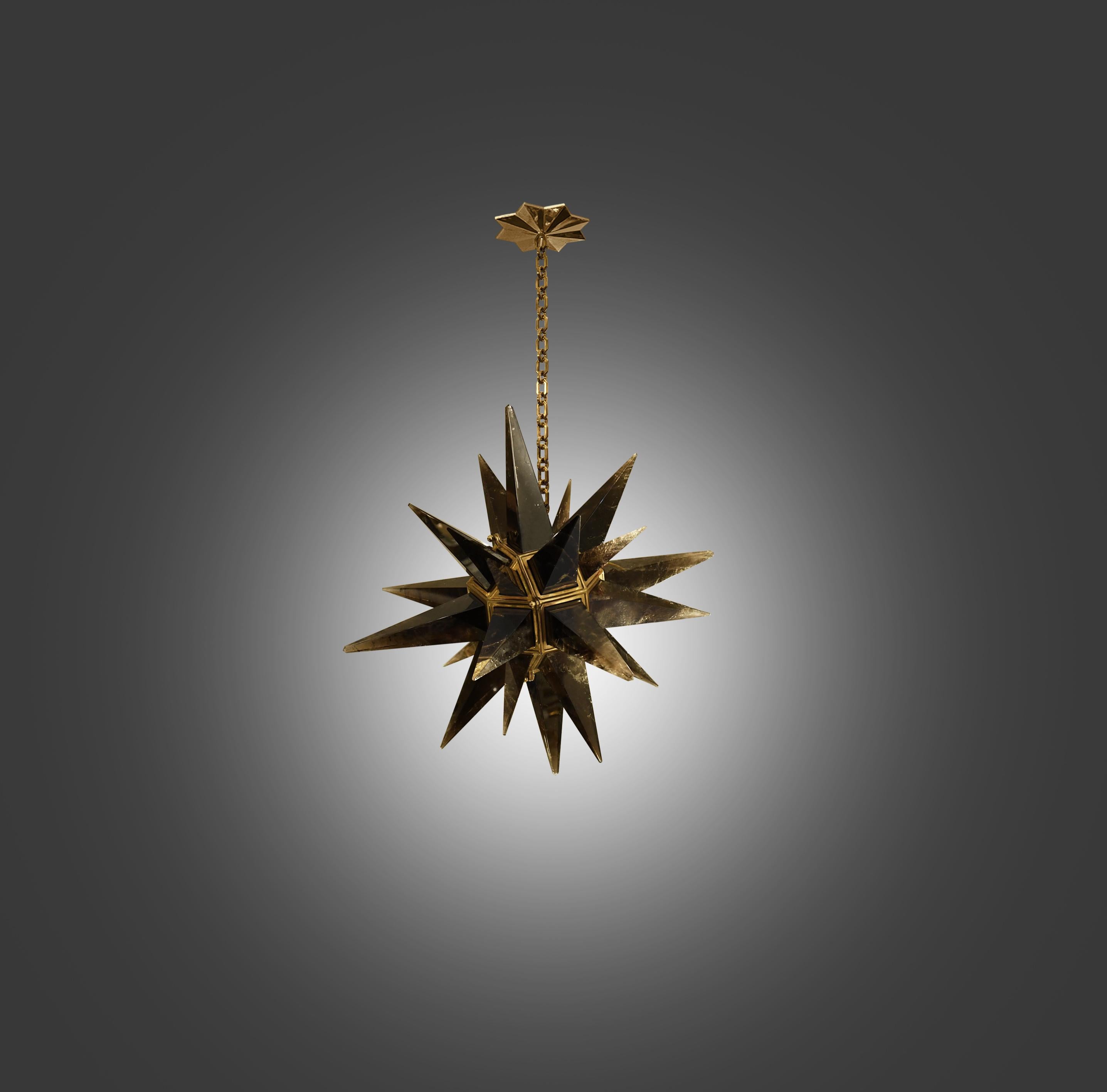 A modern dark brown rock crystal star chandelier with brass frame. Created by Phoenix Gallery, NYC.
The chandelier is 22