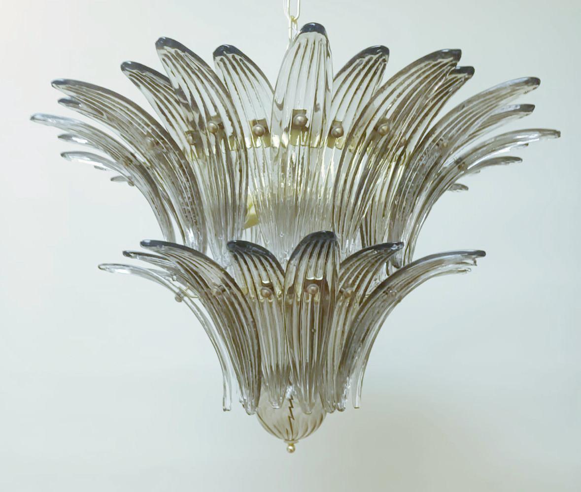Italian Palmette chandelier with smoky Murano glass leaves arranged in two tiers and mounted on gold finish metal frame / Made in Italy
6 lights / E26 or E27 type / Max 60W each
Measures: Diameter 25.5 inches, height 18 inches plus chain and