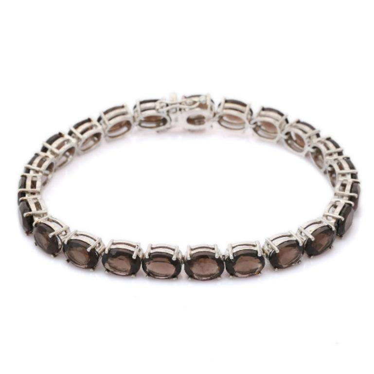 Smoky Topaz Tennis Bracelet in sterling silver showcases endlessly sparkling natural smoky topaz, It measures 7.5 inches long in length. 
Smoky Topaz stimulate concentration and reduces stress. 
Designed with perfect oval cut smoky topaz set in