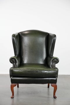 Smooth classic cowhide Chesterfield armchair in a stylish dark green color