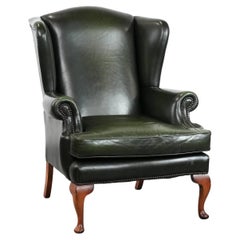Smooth classic cowhide Chesterfield armchair in a stylish dark green color