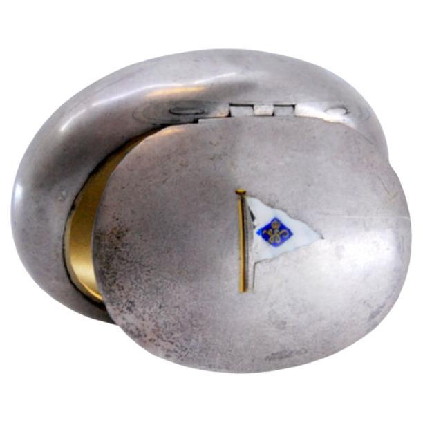 Smooth oval silver snuffbox with enamel flag and hinged lid