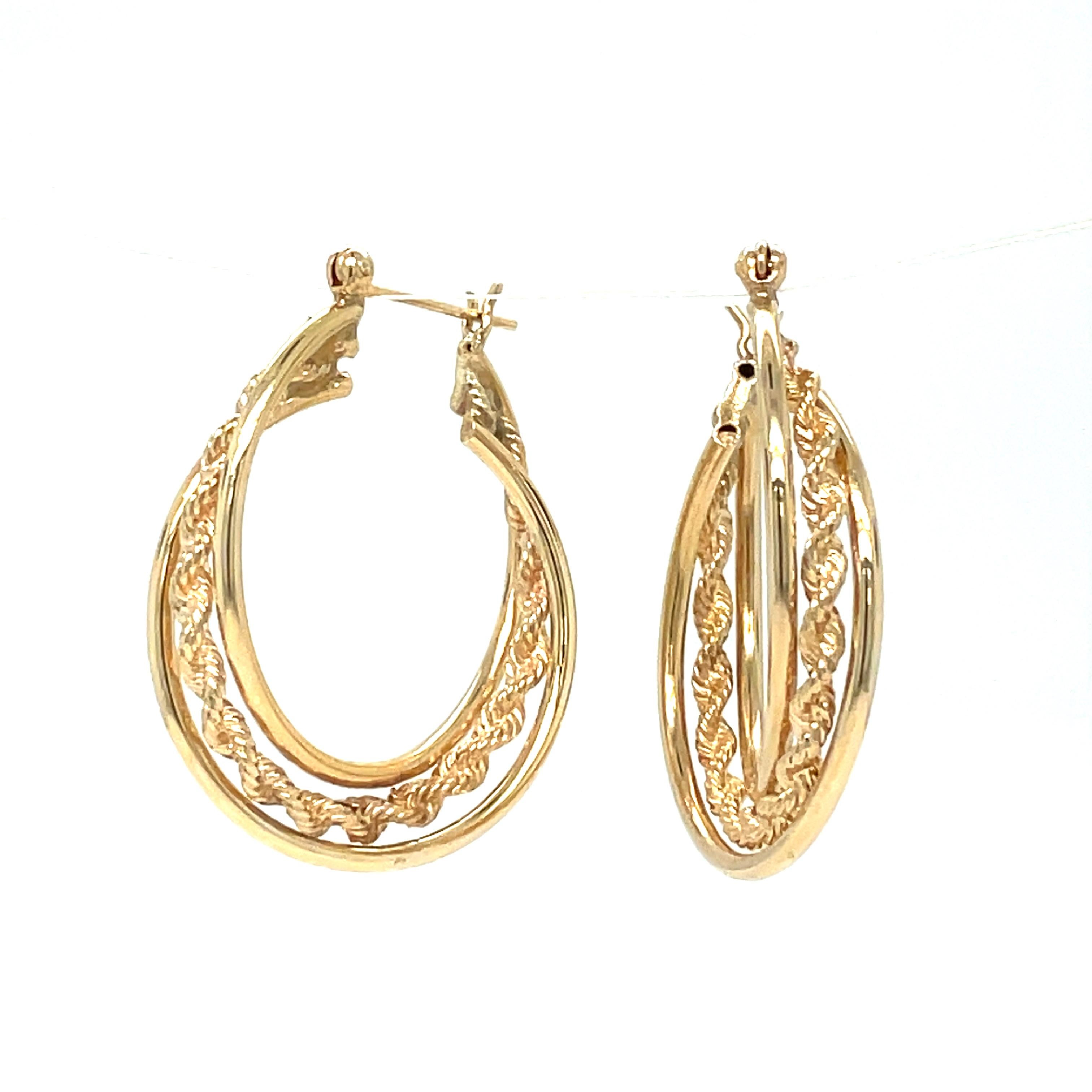 Make a bold statement with these triple hoop earrings crafted from 14k yellow gold. The sleek smooth design of the larger hoop creates a unique contrast with the rope twist of the two smaller hoops. A perfect accessory to add a touch of class to any