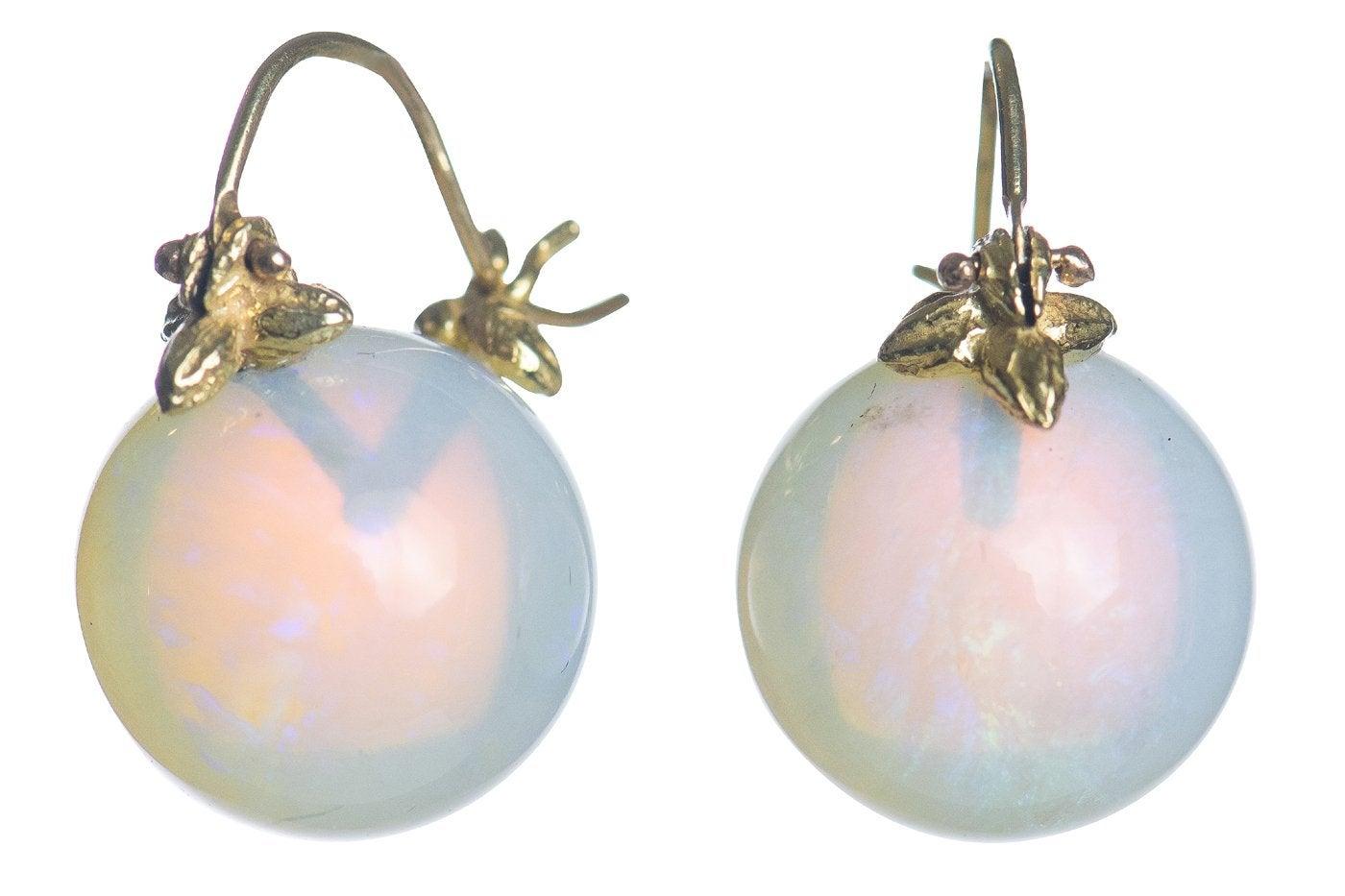 Breathtaking: these flawless 13mm smooth round Ethiopian opals possess both fire and water, with their trademark color that is somehow milky blue-green and golden warmth at once. On the signature 18k Flyer setting.

GS513EtOp-1  13mm smooth round